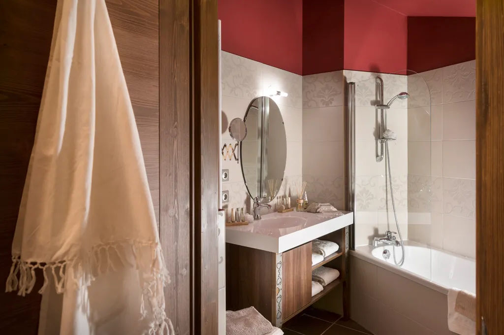 image Bathroom with full bathtub, walk-in shower, and oval mirror — soak away the altitude after a day of hiking at 2,300m.
