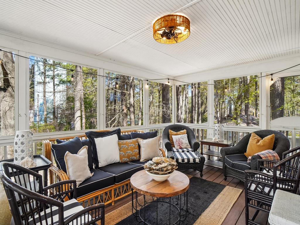 image Spacious and relaxing sunroom with plush seating and outdoor views