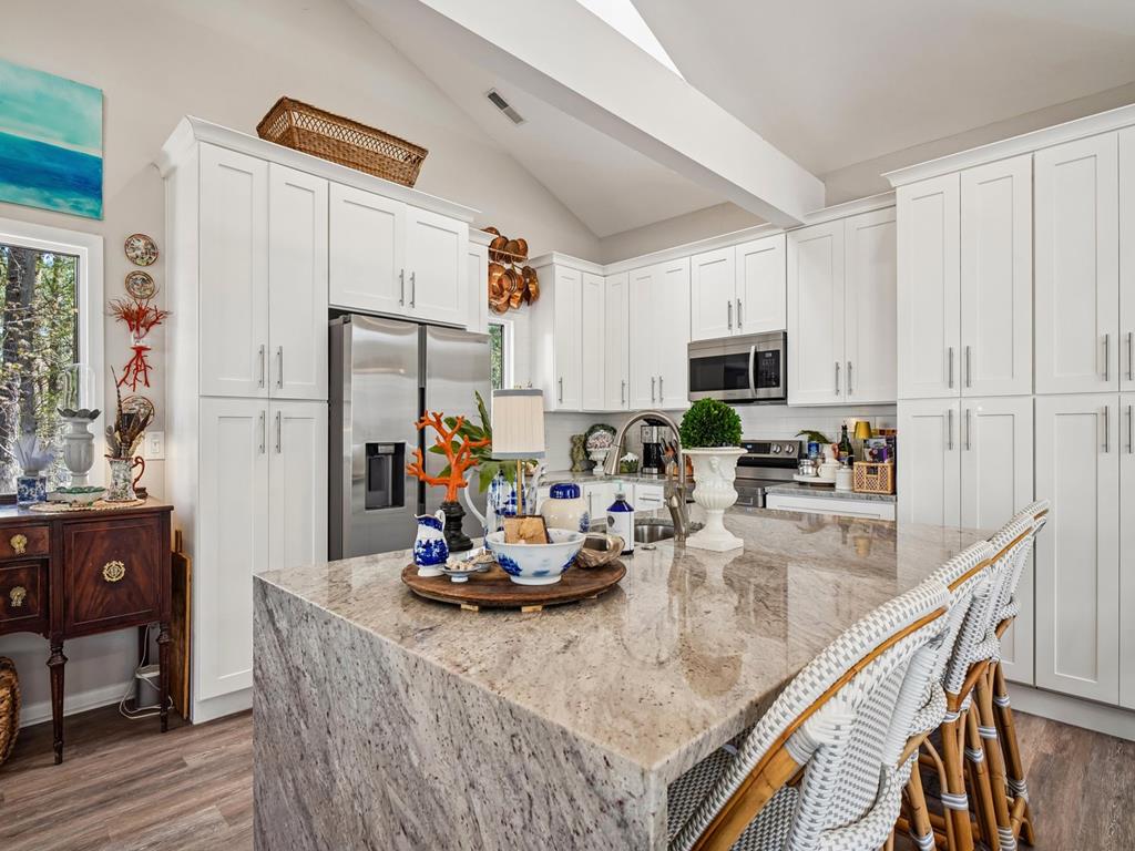 image Kitchen island with bar seating and pendant lights — open to the great room on the third level
