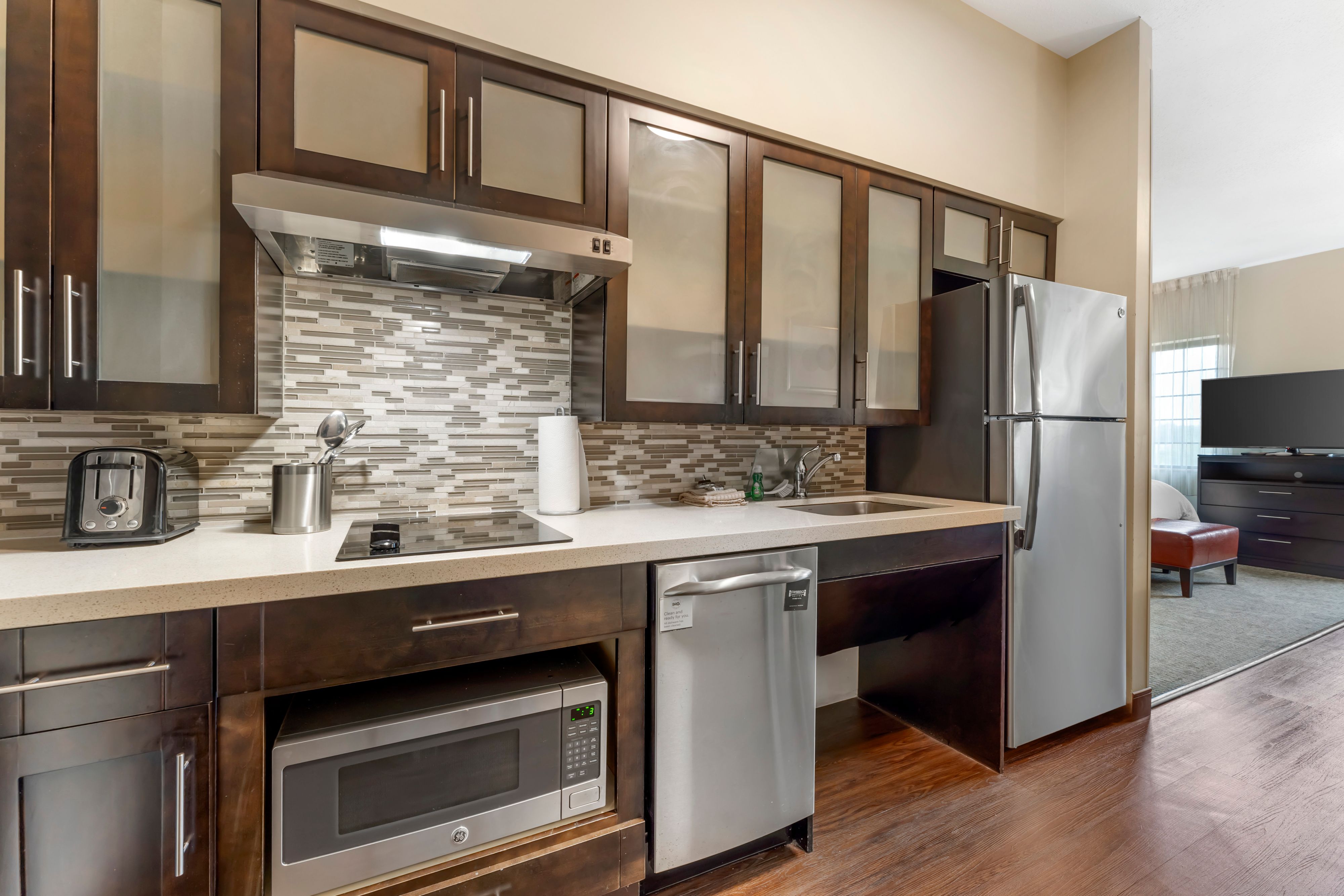 image Fully equipped kitchen with sleek appliances and ample counter space.