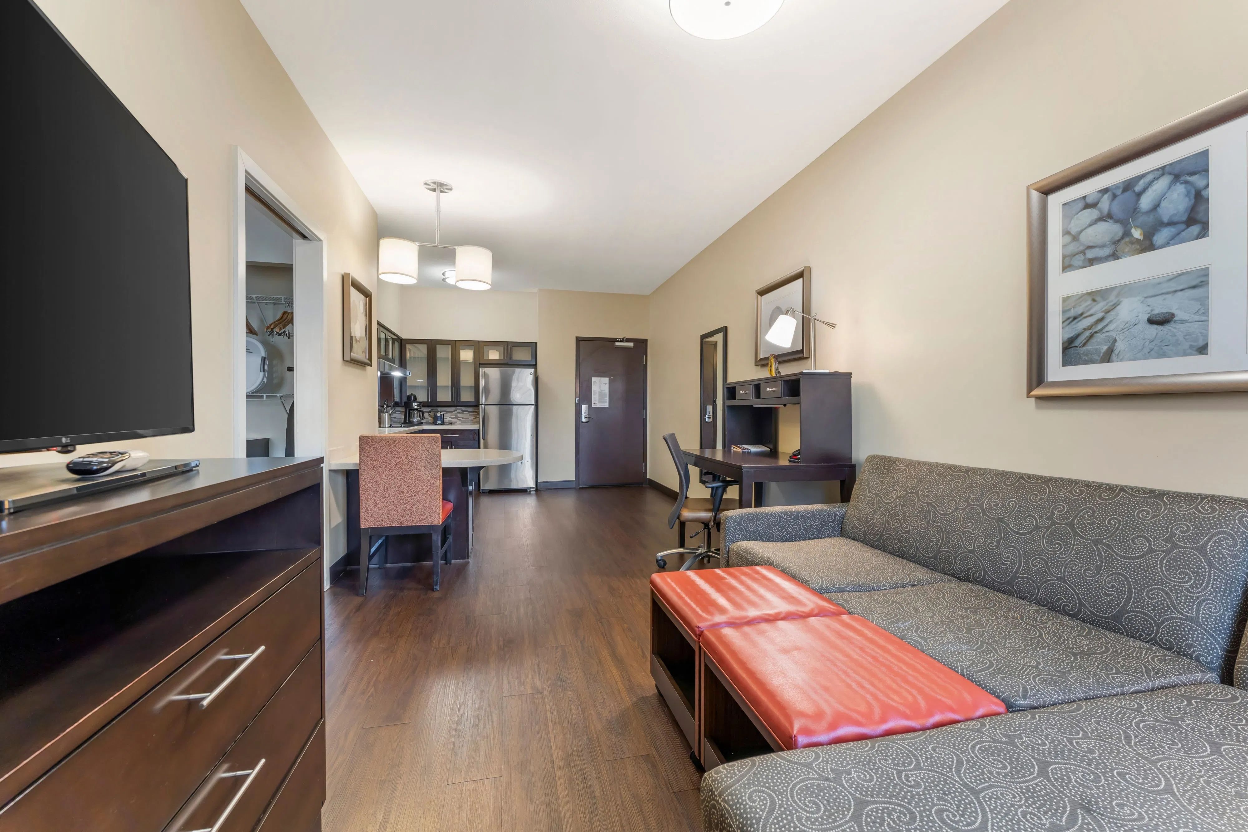 image Spacious living area with sofa, dining space, and fully equipped kitchen