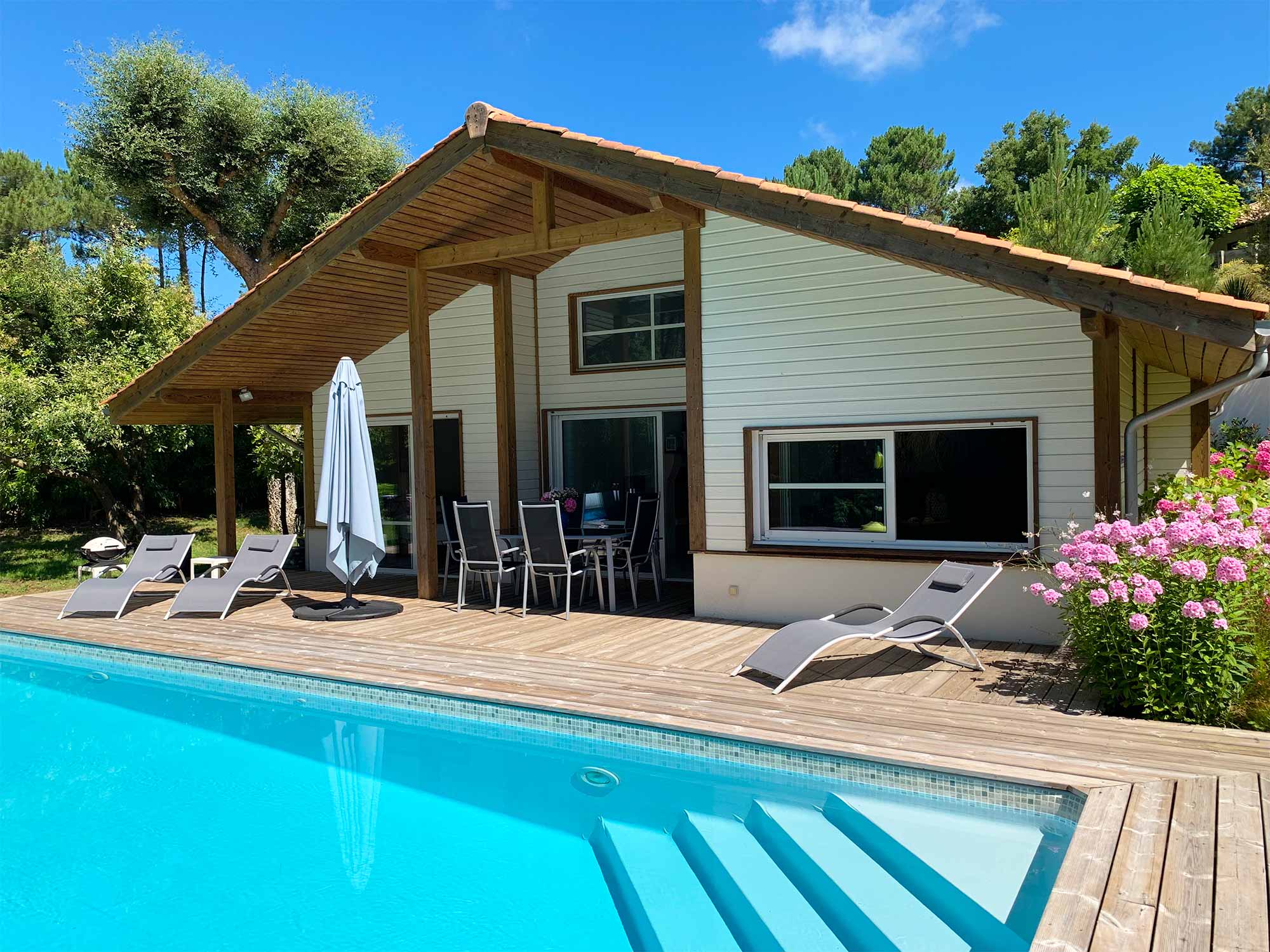image Your private pool and sun loungers on a wide wooden deck — the pine forest just behind, the Atlantic beach 2 km away.