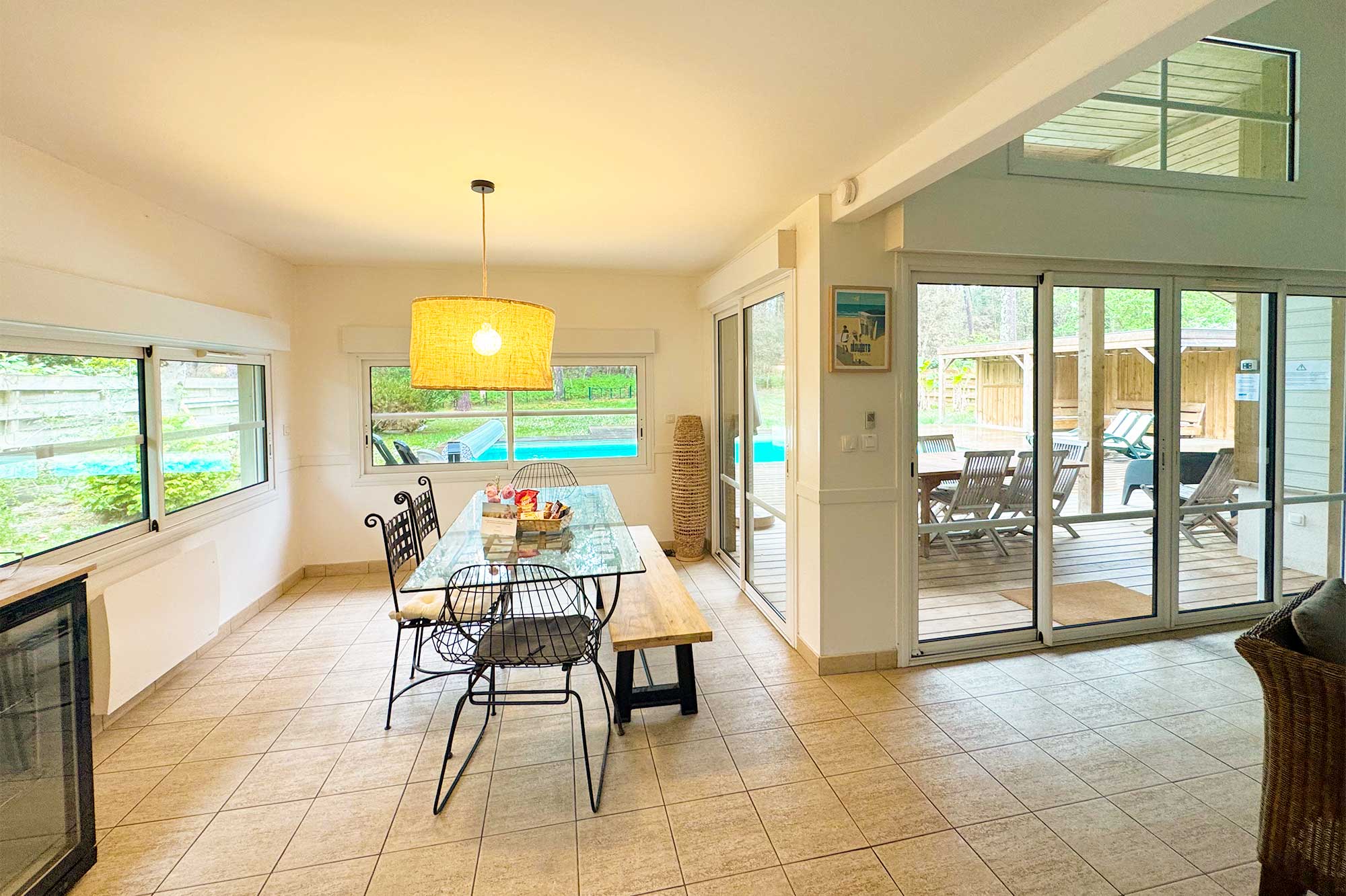 image Open-plan kitchen and dining space flooded with natural light, with sliding doors opening straight onto the terrace and garden.