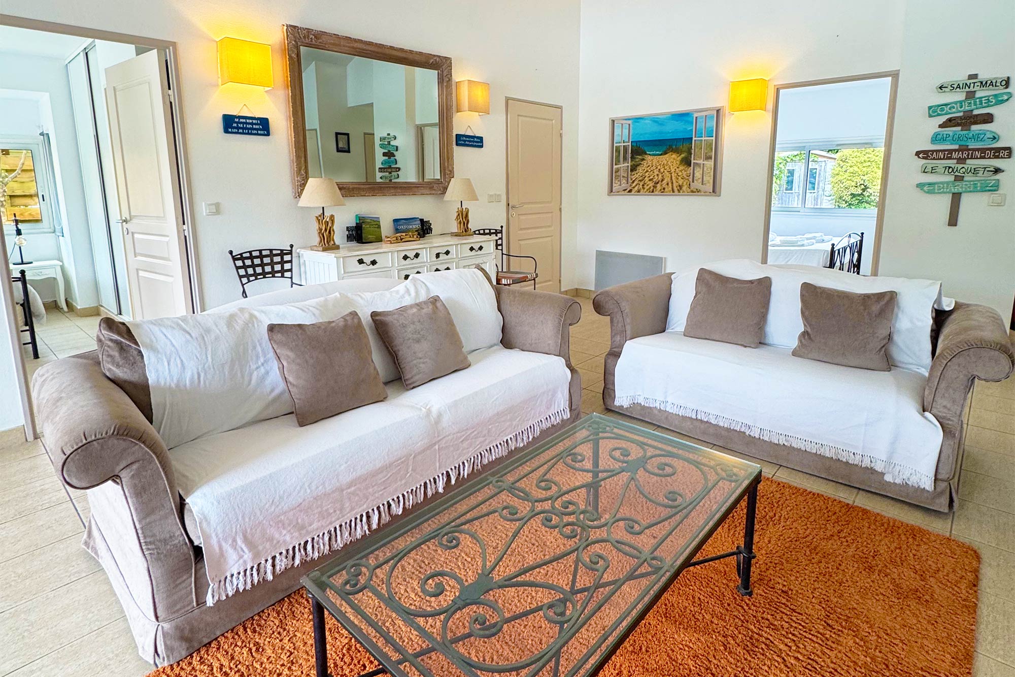 image Living room, sofa with cushions, orange patterned rug, warm lighting, coastal artwork on walls:
Warm tones, coastal art, and quality furnishings give this Signature villa its distinct character — a true home away from home in the Landes.