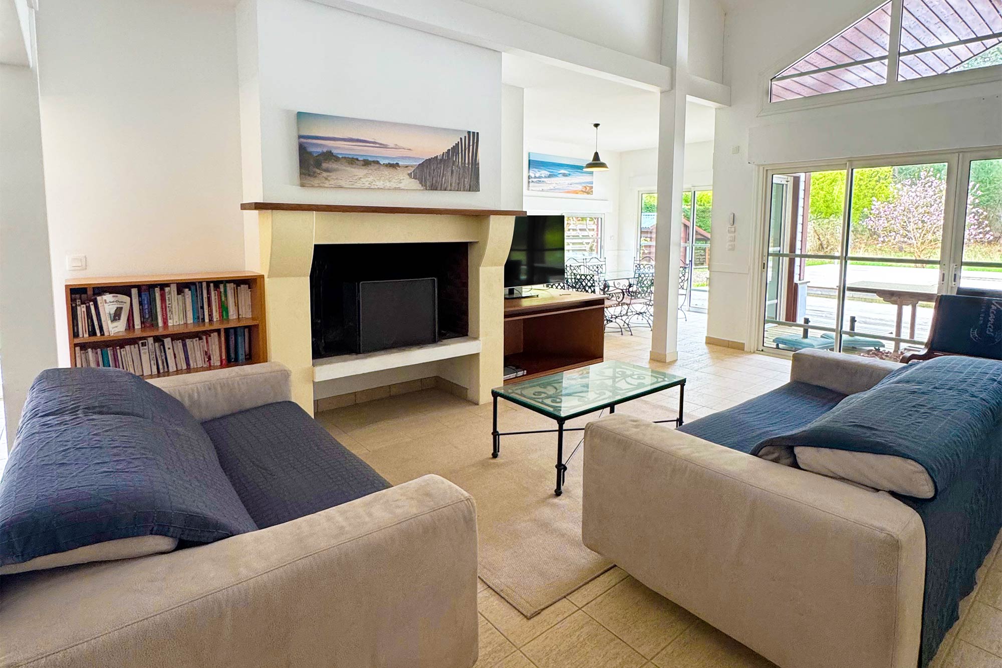 image Sun streams into the open living room, where a fireplace and high ceilings set the tone for slow evenings in the forest.