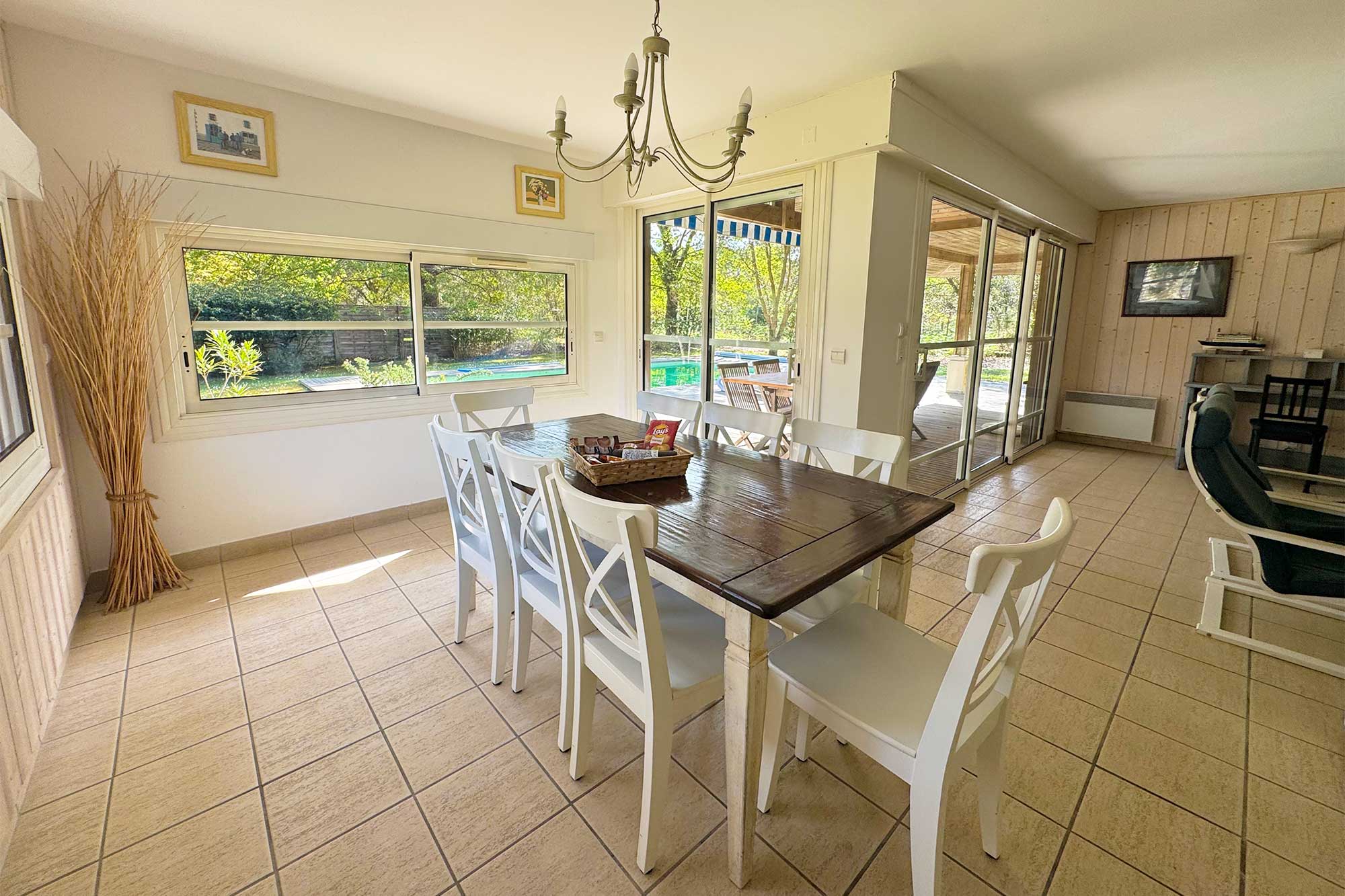 image The dining table seats the whole group, with garden and pool views — breakfast delivery arrives here each morning.