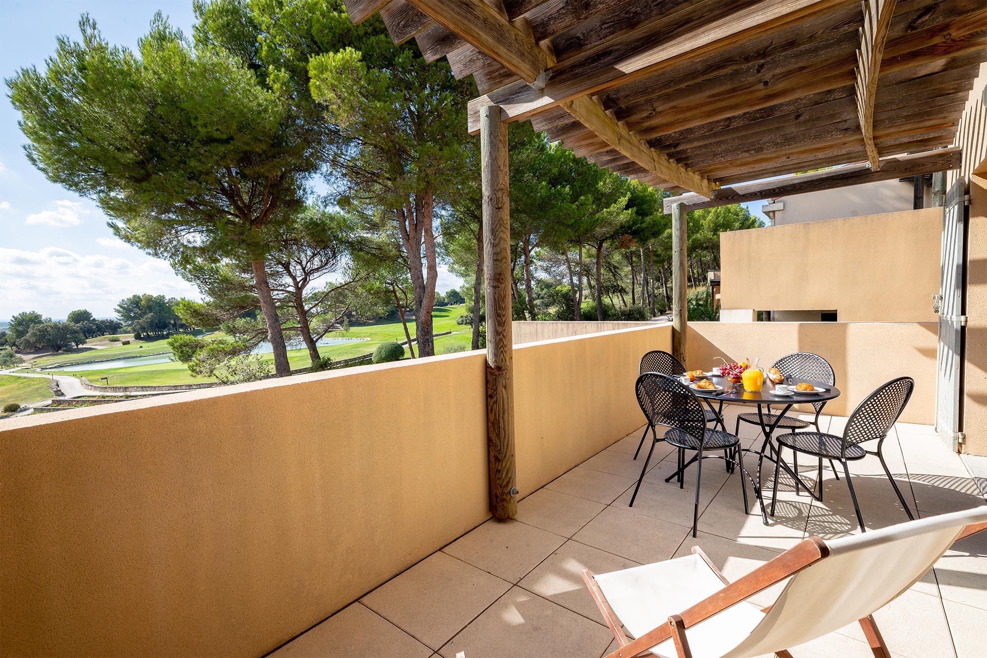 image Dine al fresco under the pergola with sweeping views of the Saumane Golf Course right at your feet.