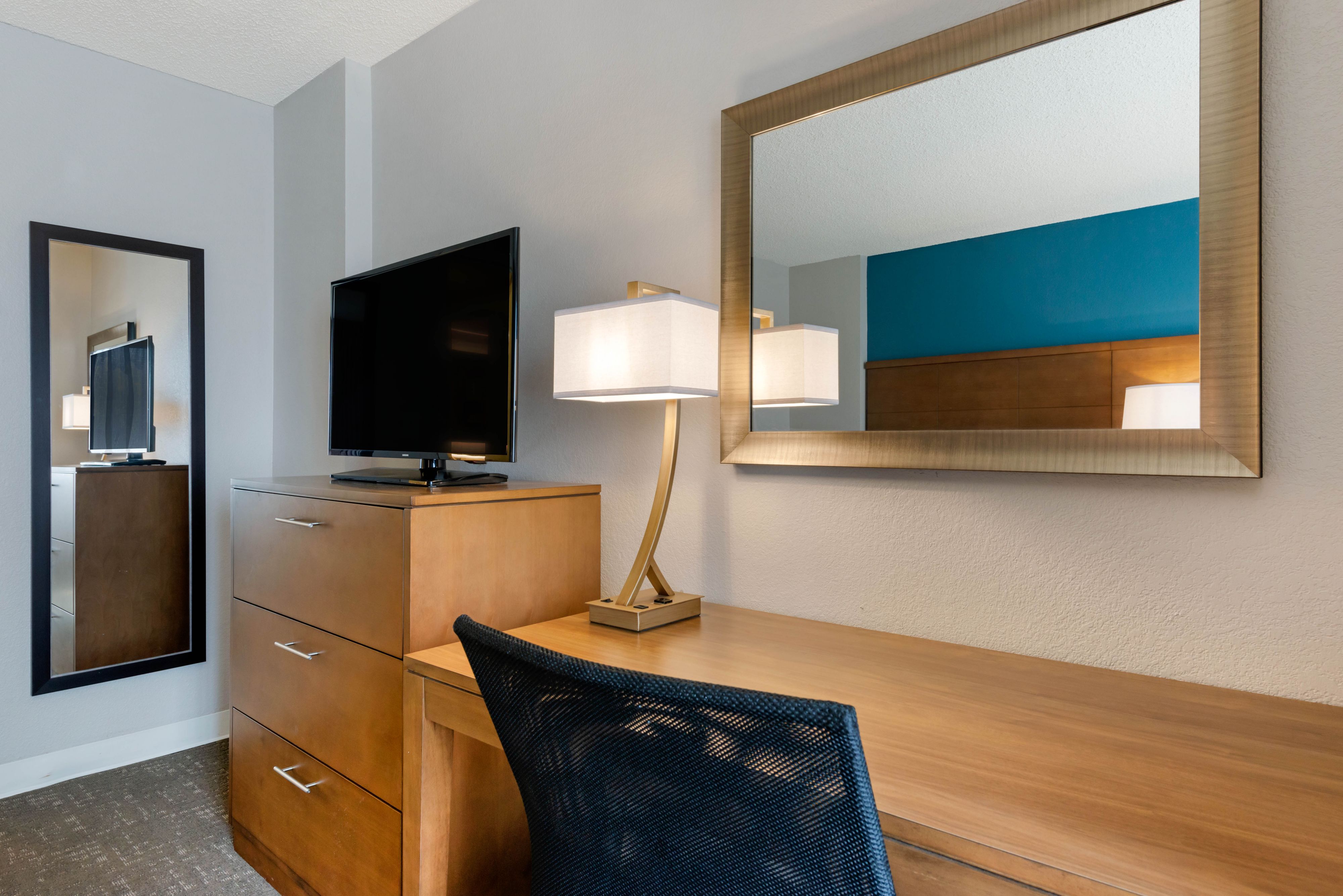 image Desk with a television and storage cabinet in the corner.