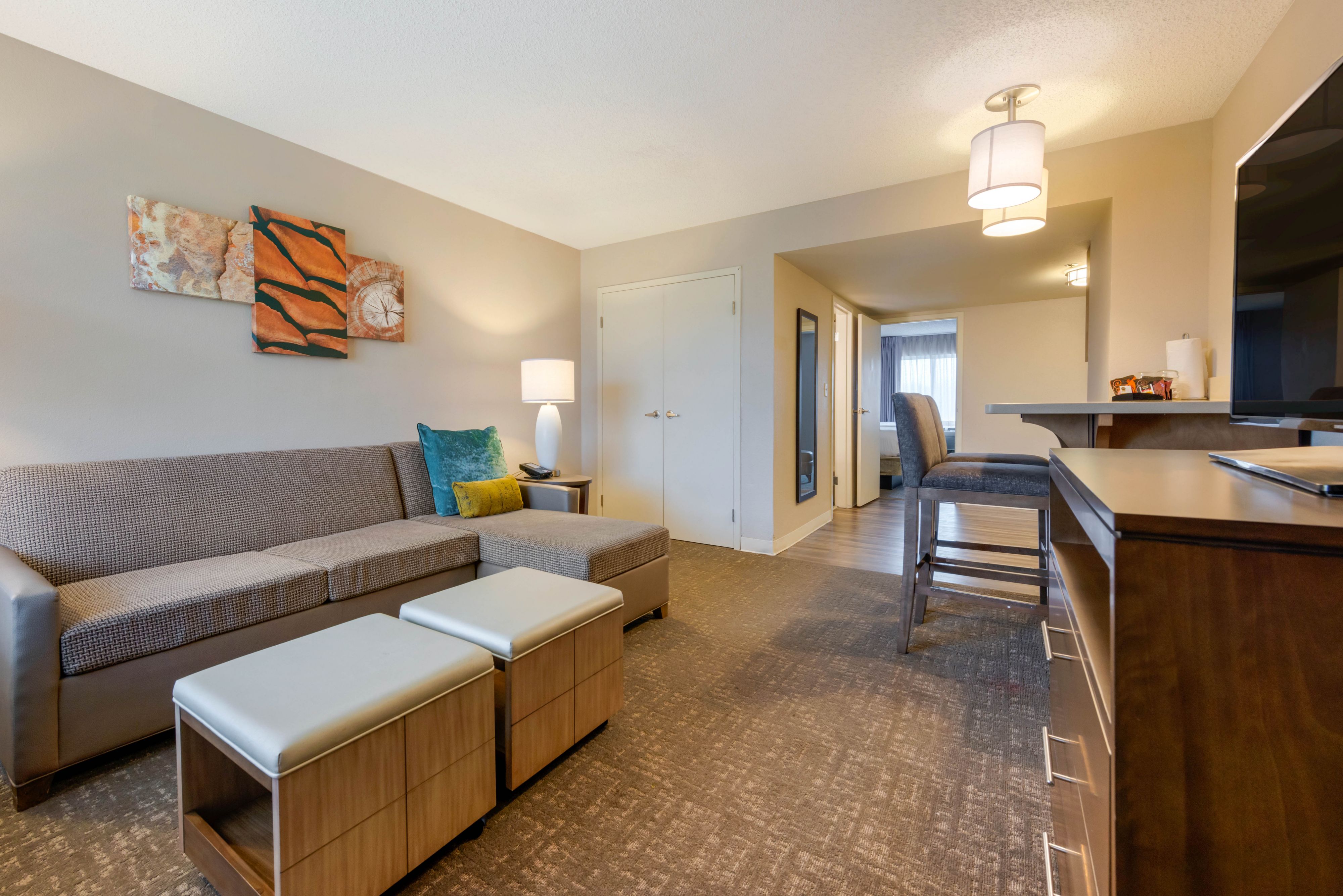 image Living area with sofa, coffee tables, and artwork.