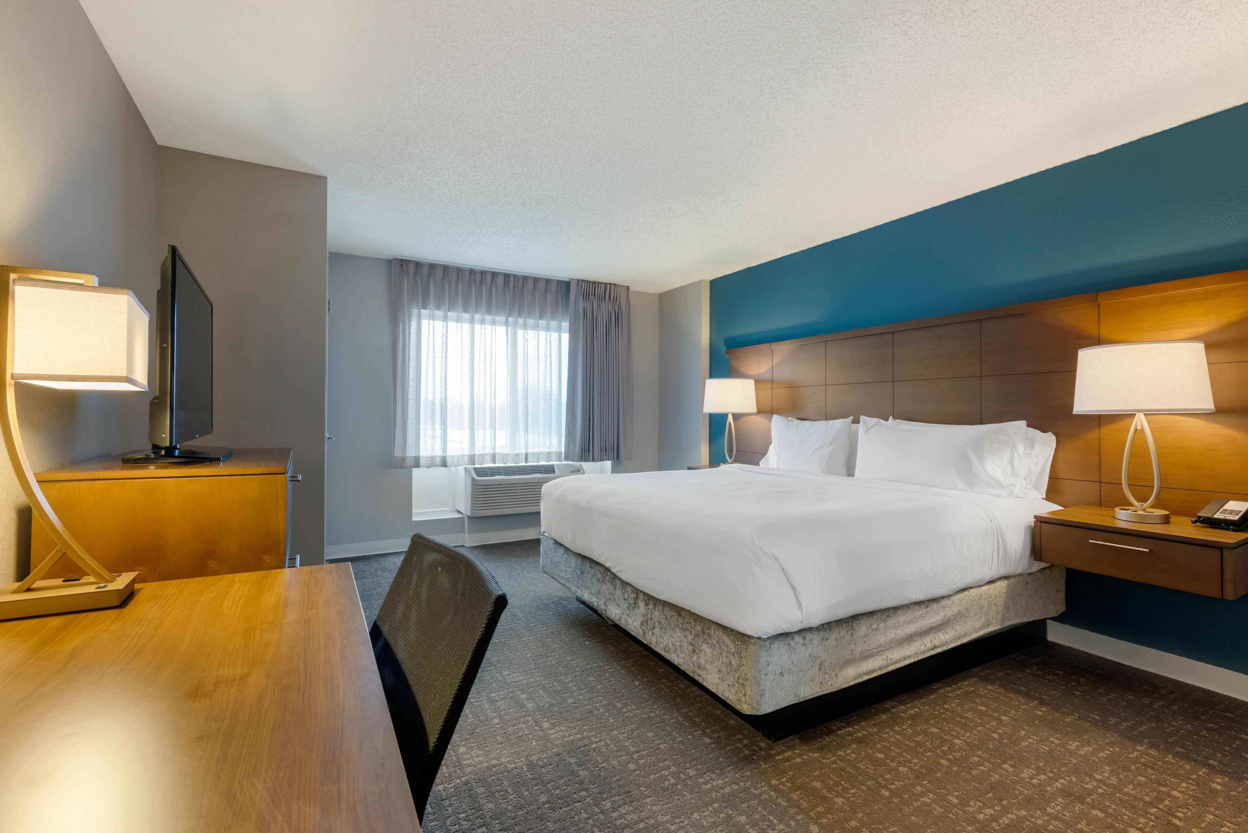 image Spacious bedroom with a king-size bed and two bedside lamps.