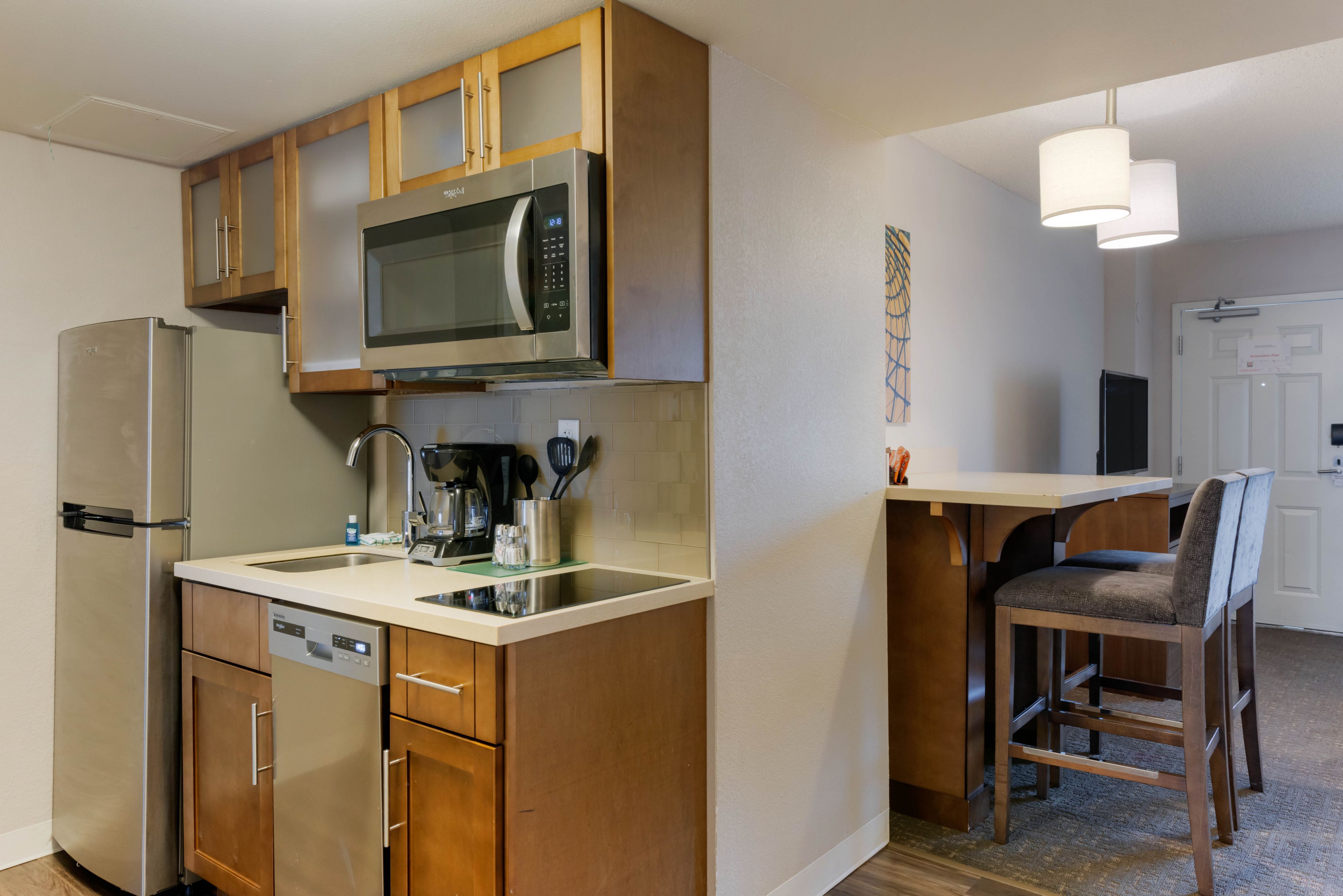 image Fully equipped kitchen with stainless steel appliances and counter space.