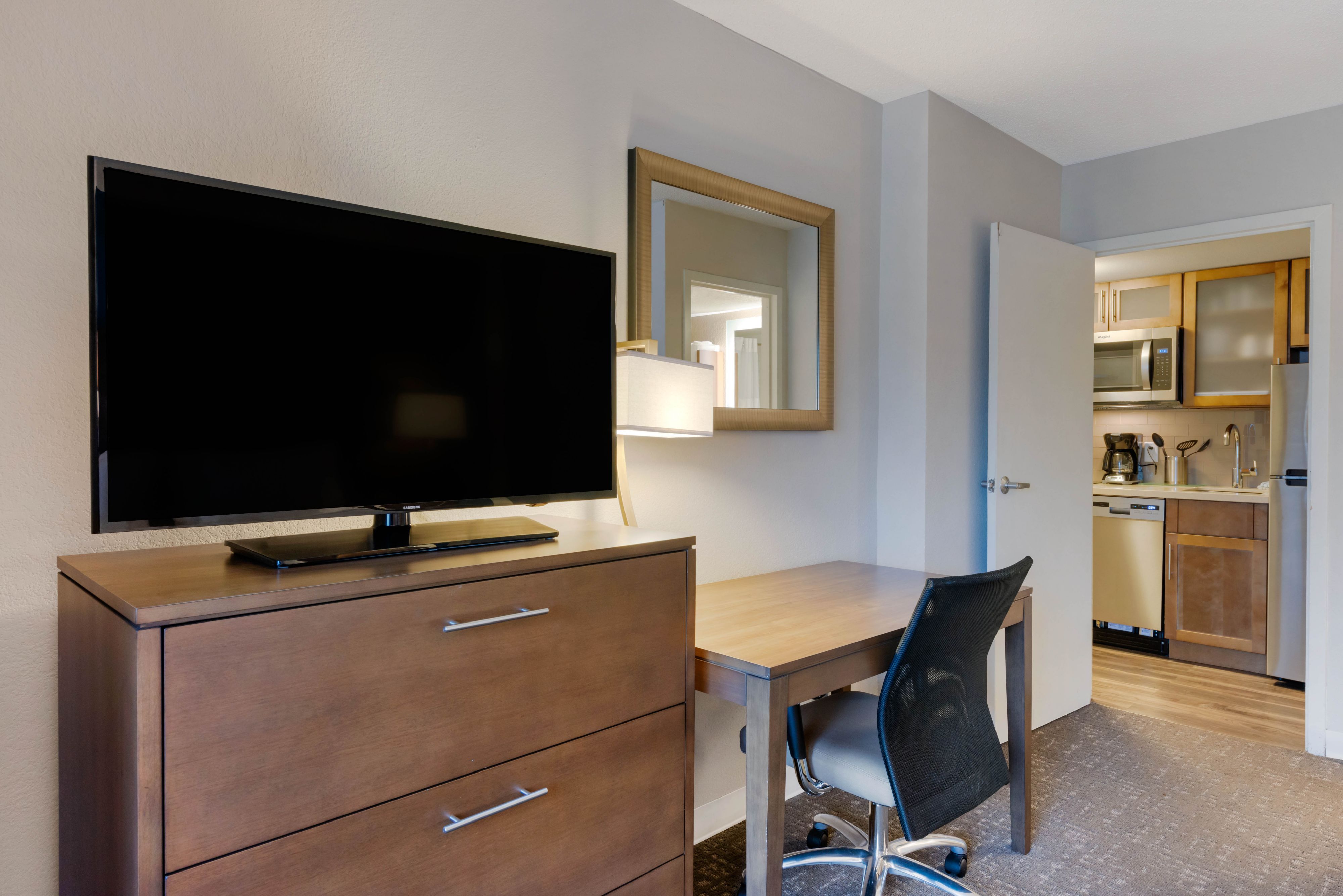 image Desk and TV area with kitchen view.