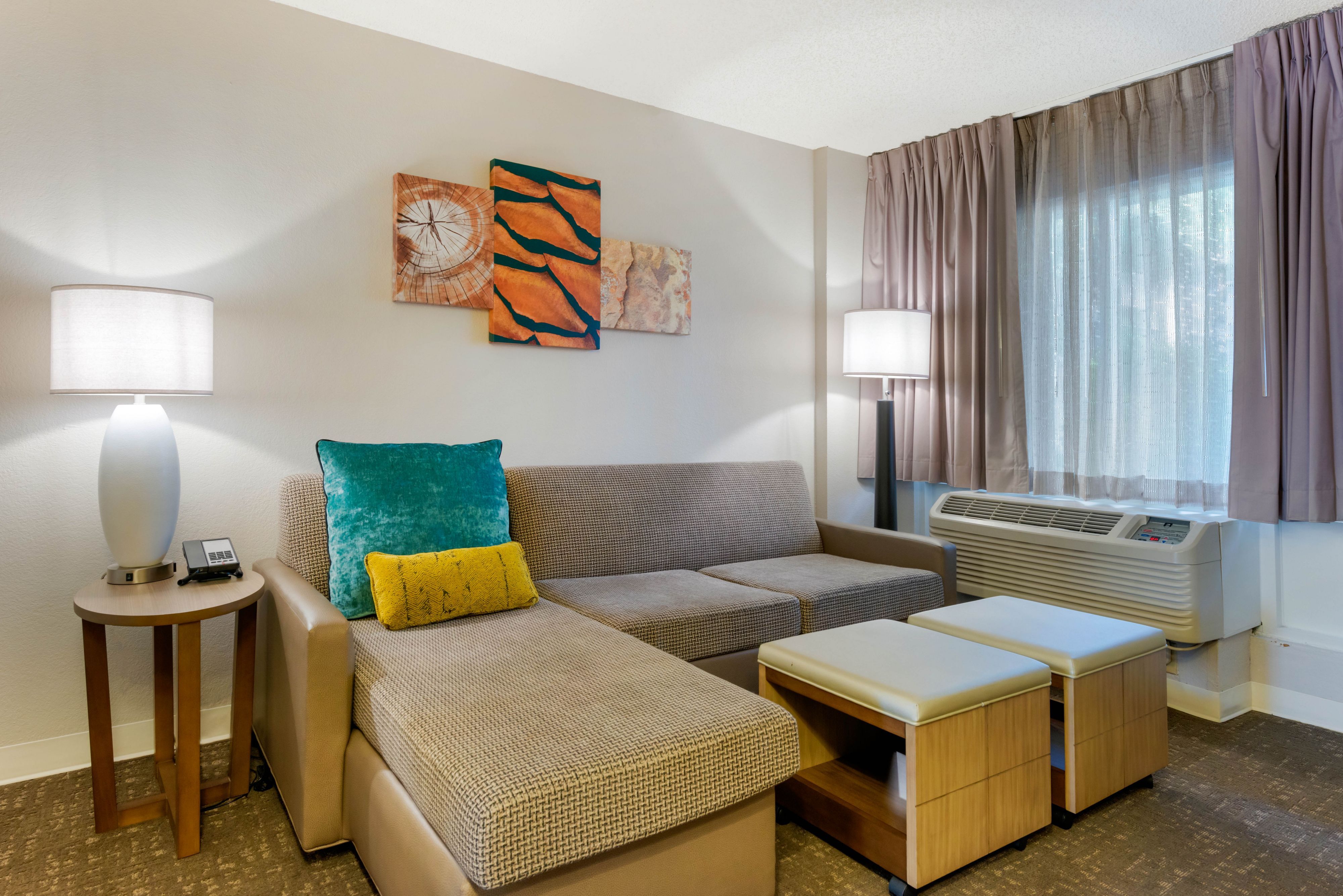 image Living area with sofa, artwork, and decorative lighting.