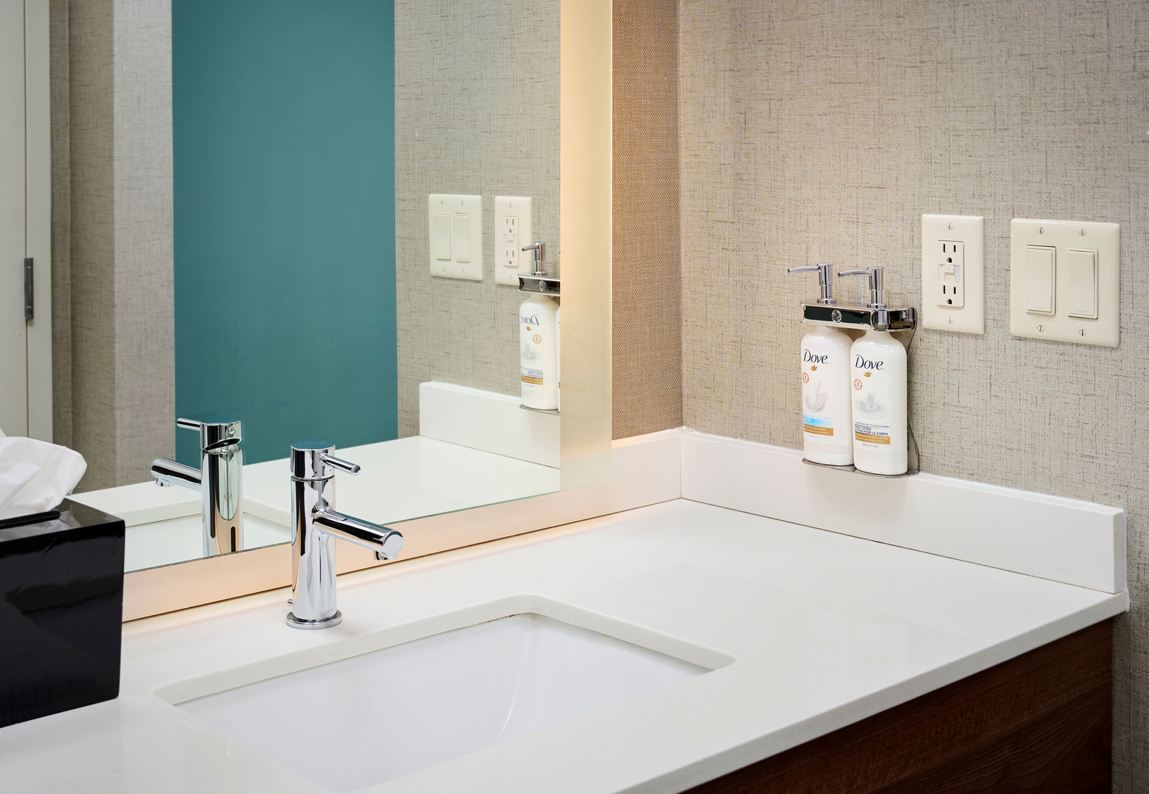 image Bathroom vanity with sink and toiletries.