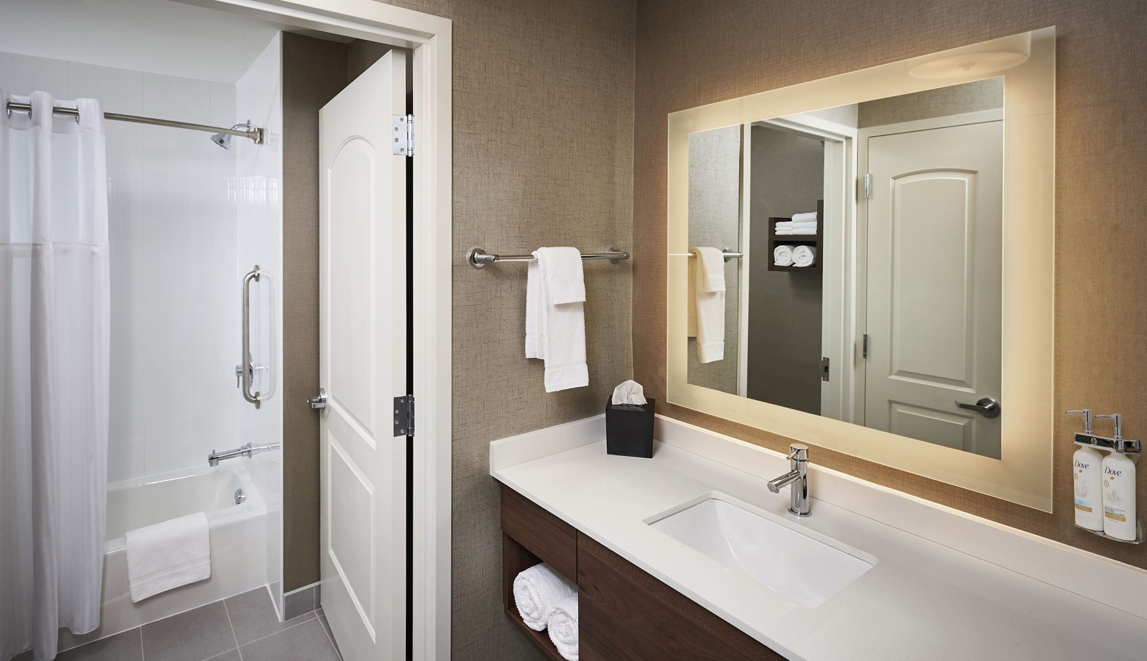 image Bathroom with shower, sink, and towels.