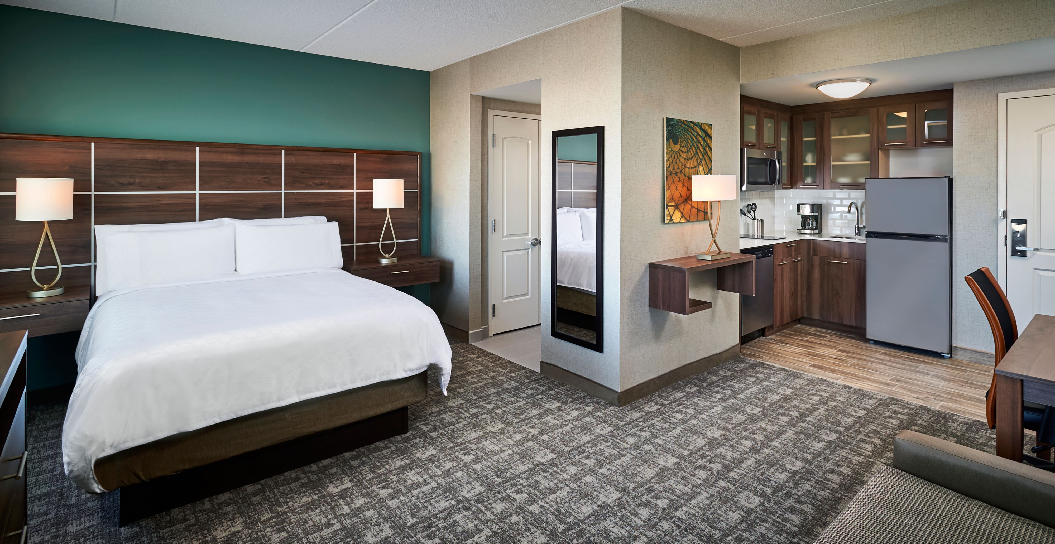 image Studio suite with queen bed, kitchen, and seating.