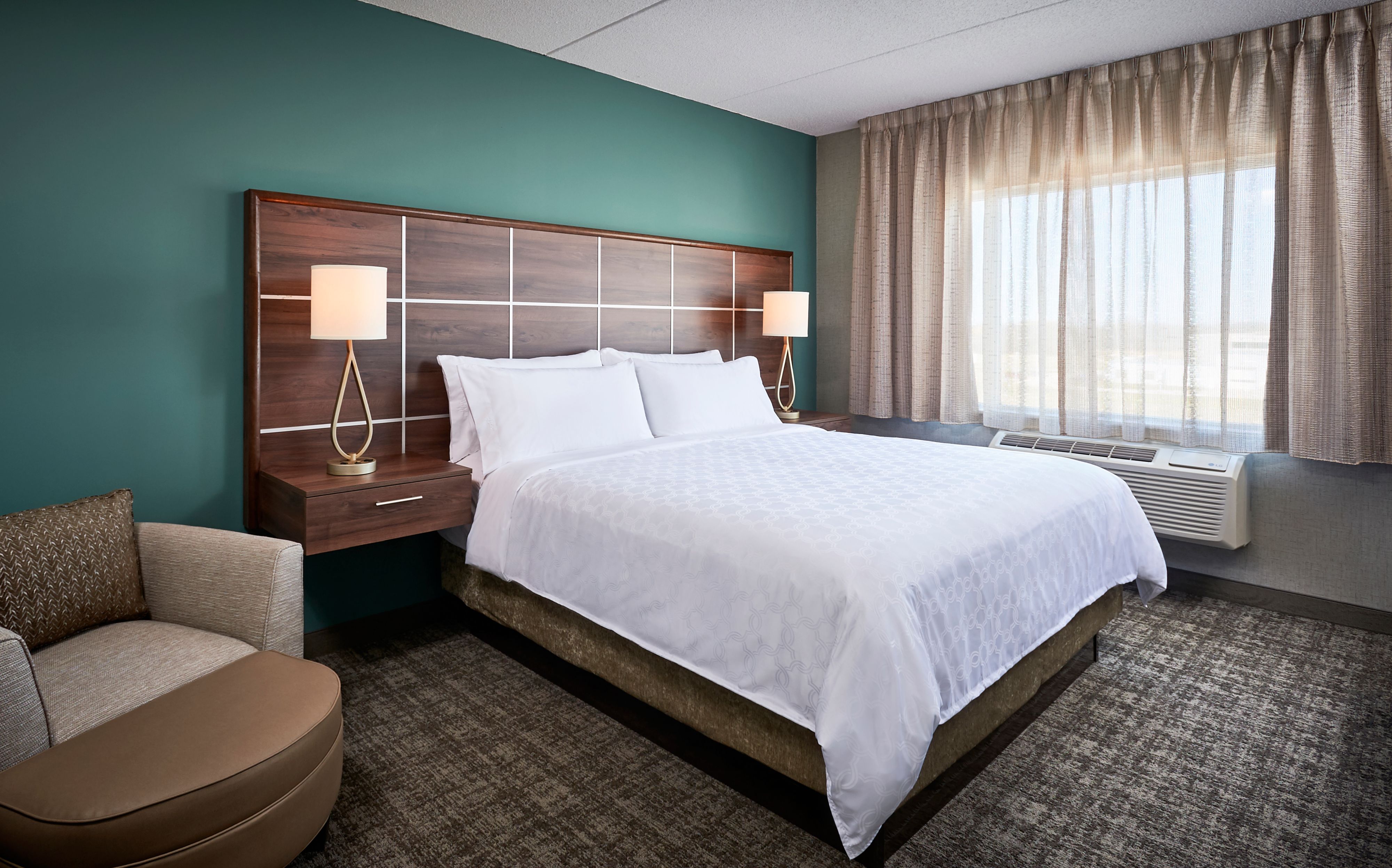 image King bedroom with bed, lamp, and chair.