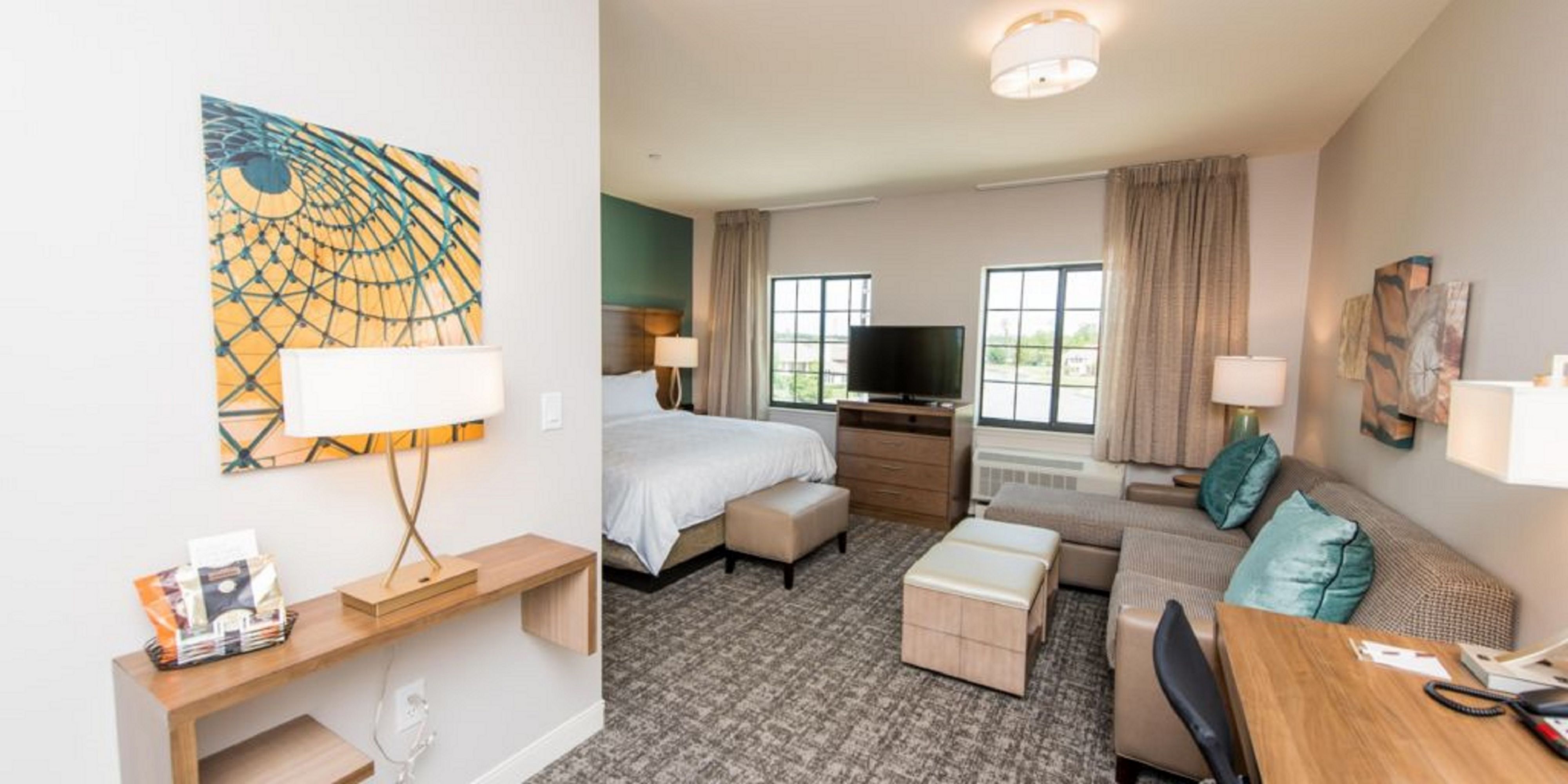 image Relax in a stylish studio, featuring a plush king bed and cozy seating area for unwinding after adventures.