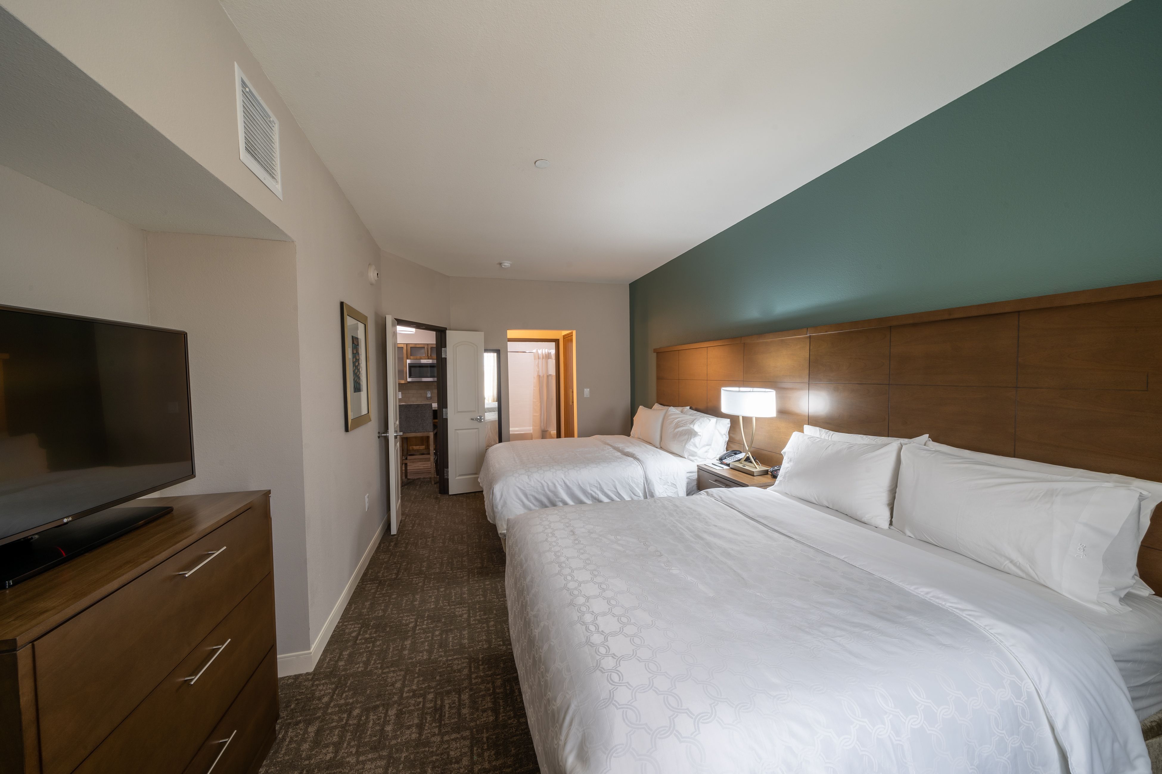 image Sleep peacefully in the spacious bedroom with two plush queen beds and inviting decor.