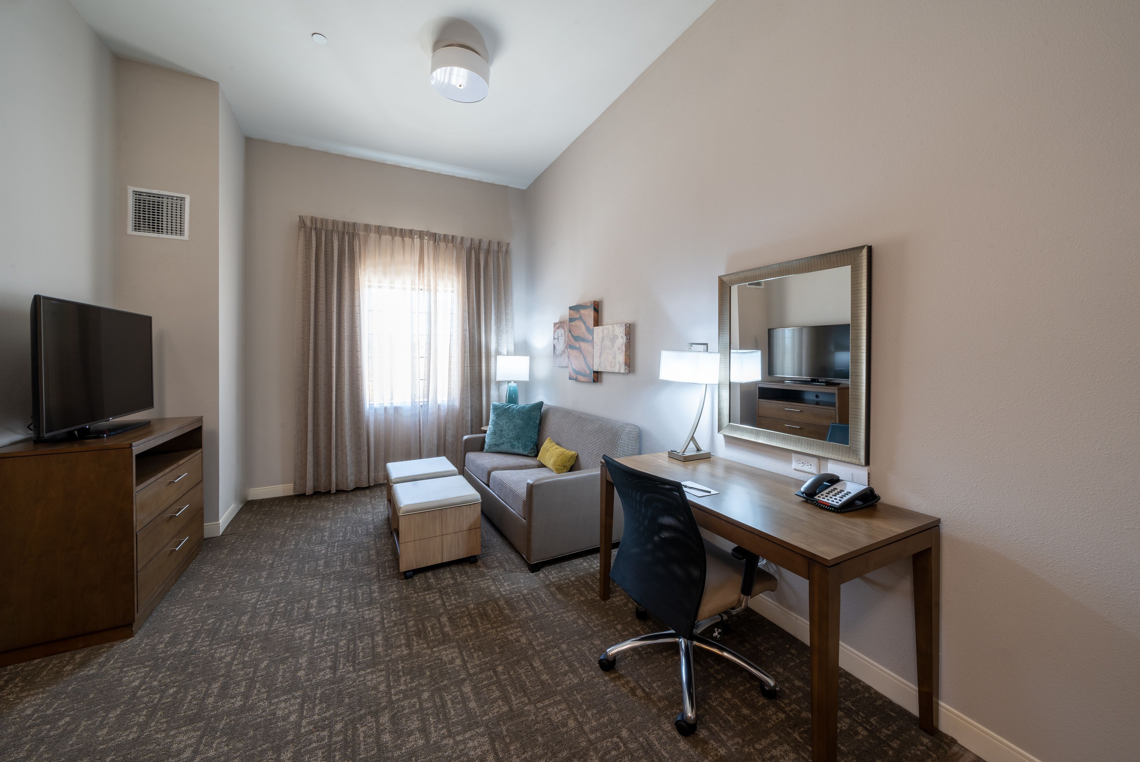 image Relax in the cozy living area with natural light streaming through the windows.