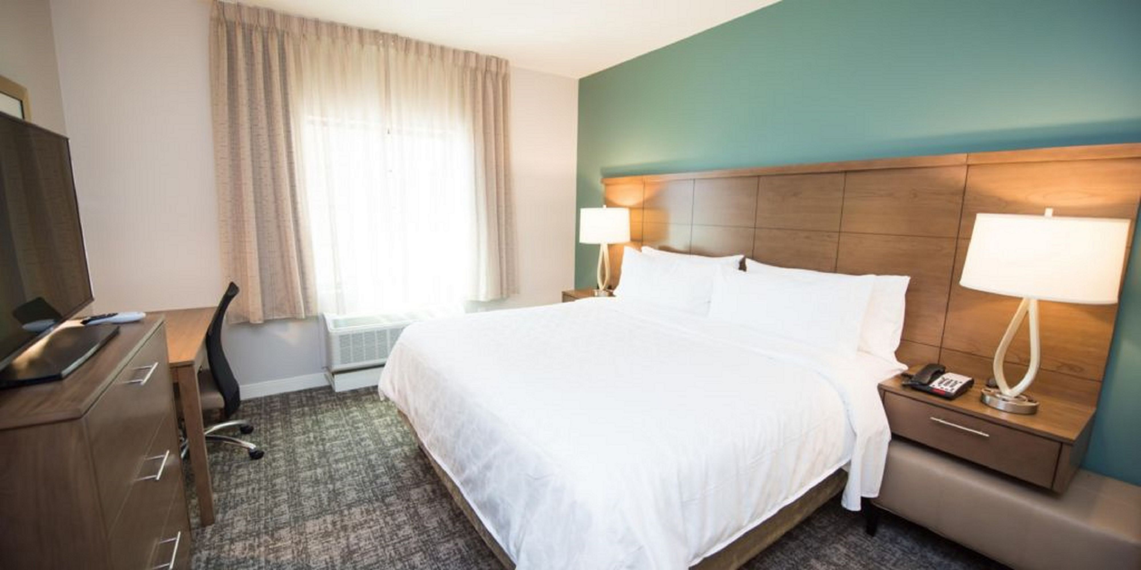 image Enjoy a restful night on the comfortable king bed, surrounded by soothing décor.