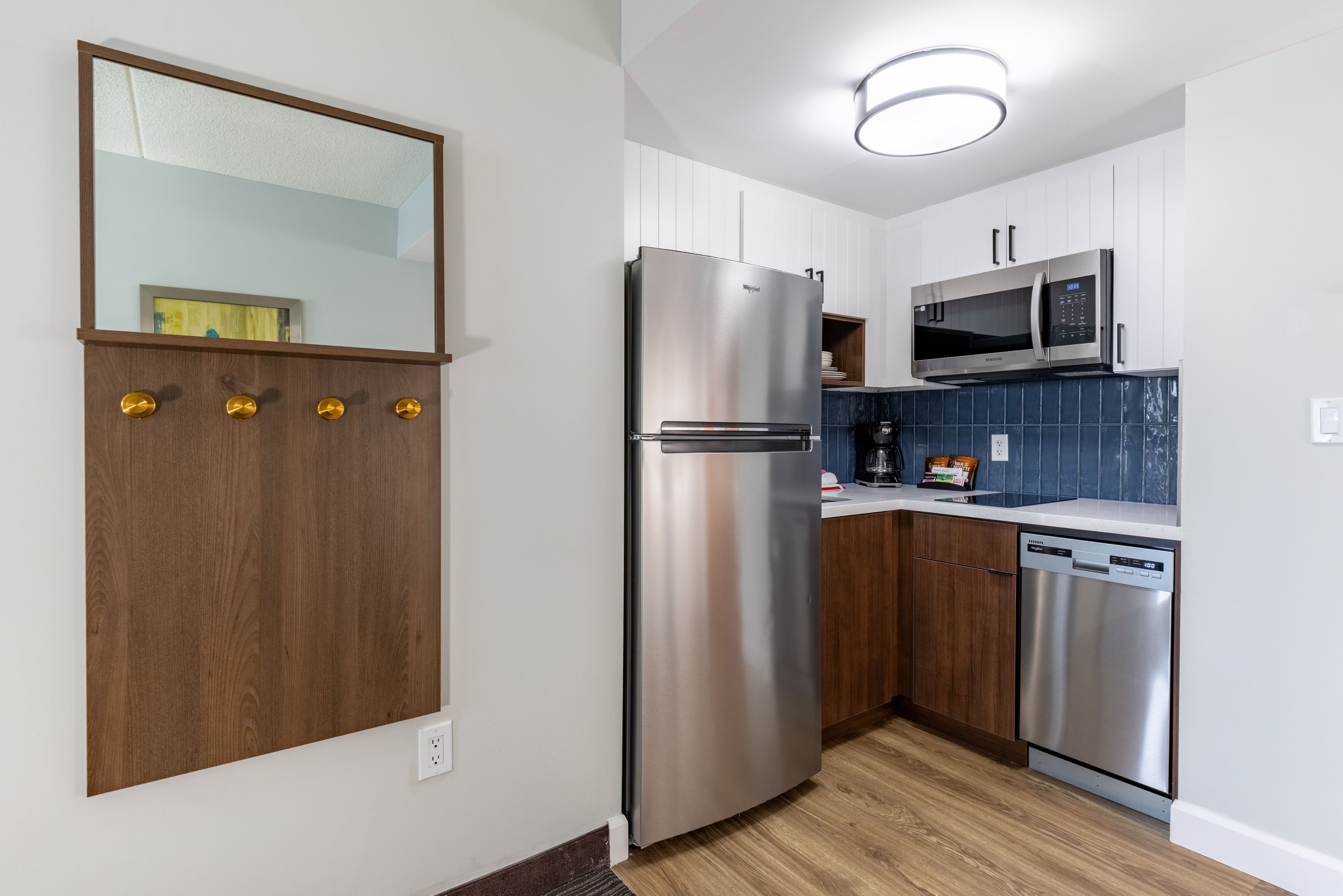 image Full kitchen with stainless steel appliances, dishwasher, and coffee maker.