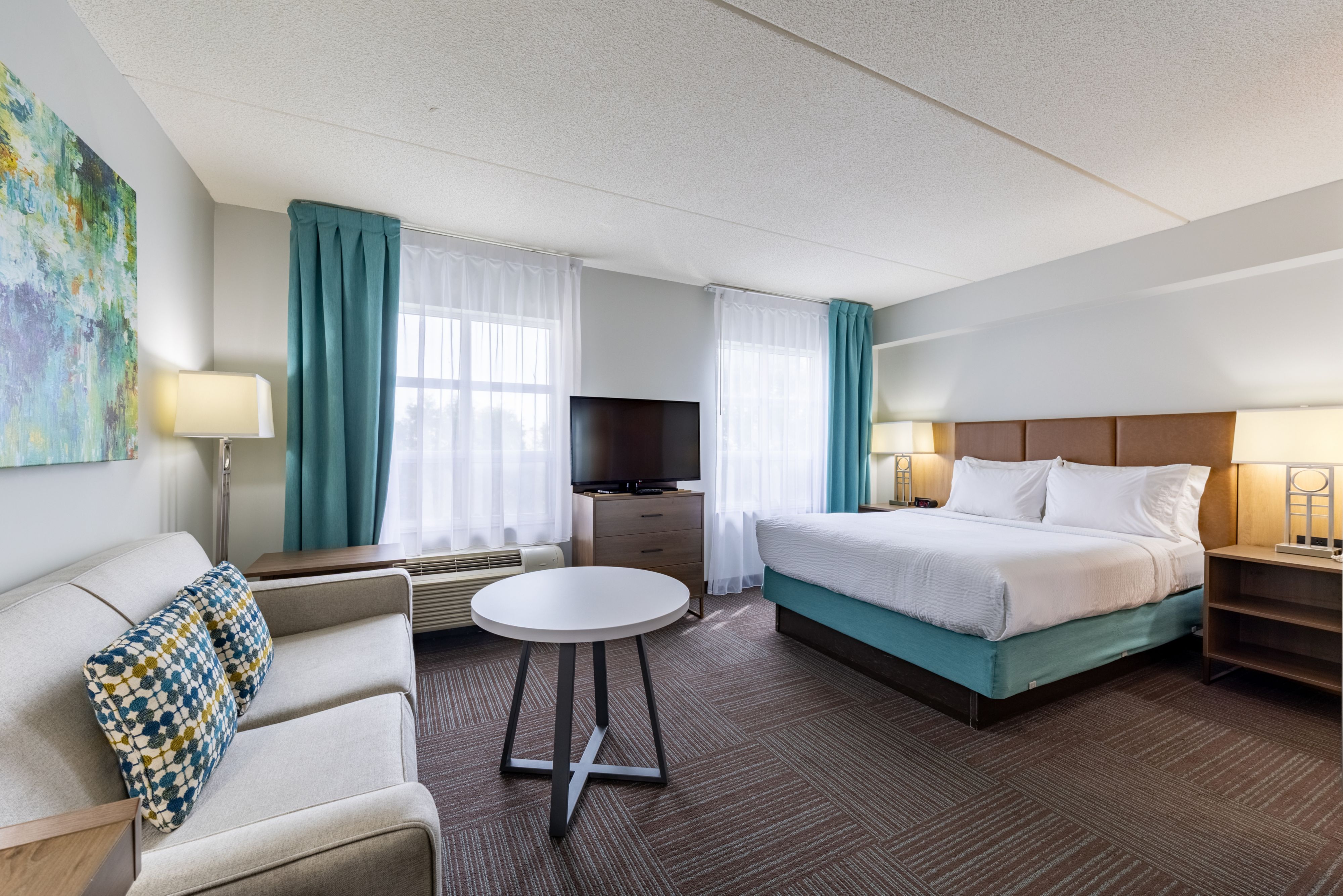 image Spacious studio with queen bed and comfortable seating area.