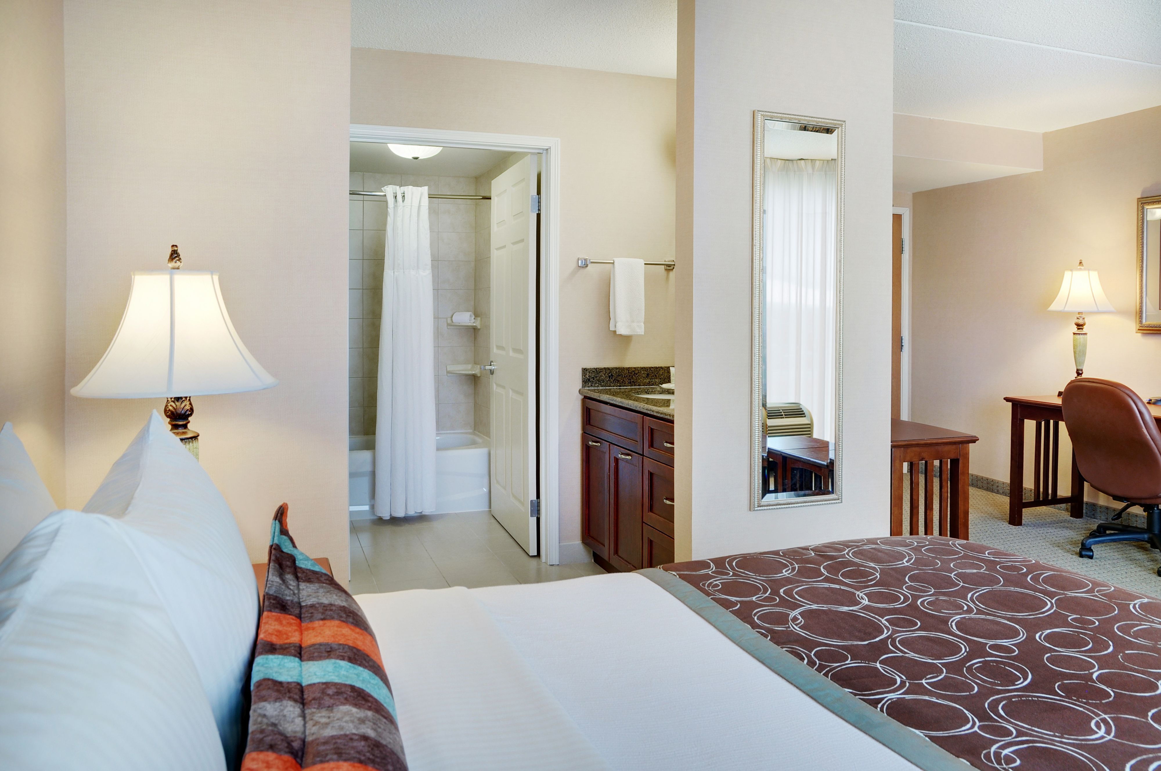 image Bedroom with soft linens and comfortable bedside amenities.
