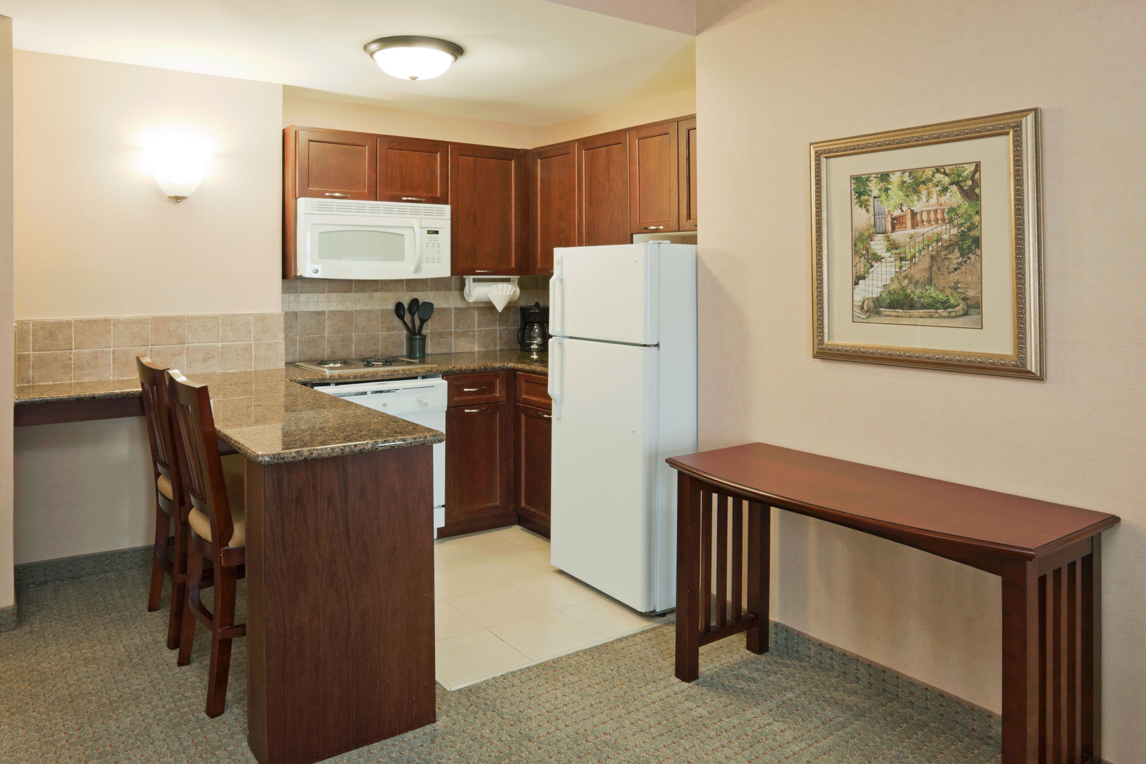 image Well-equipped kitchen with modern appliances and dining space.