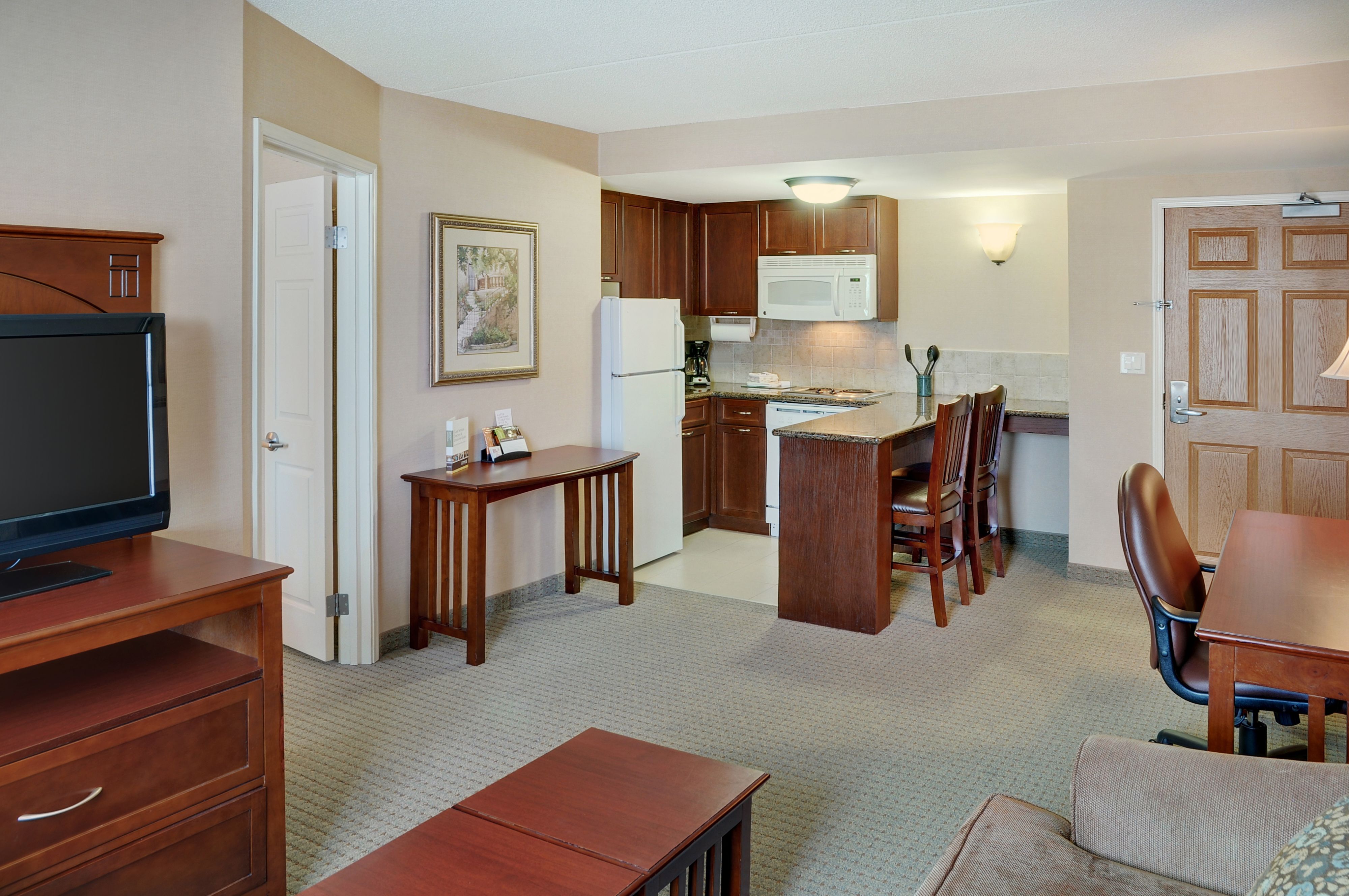 image Open-plan living area with kitchen bar and dining space.