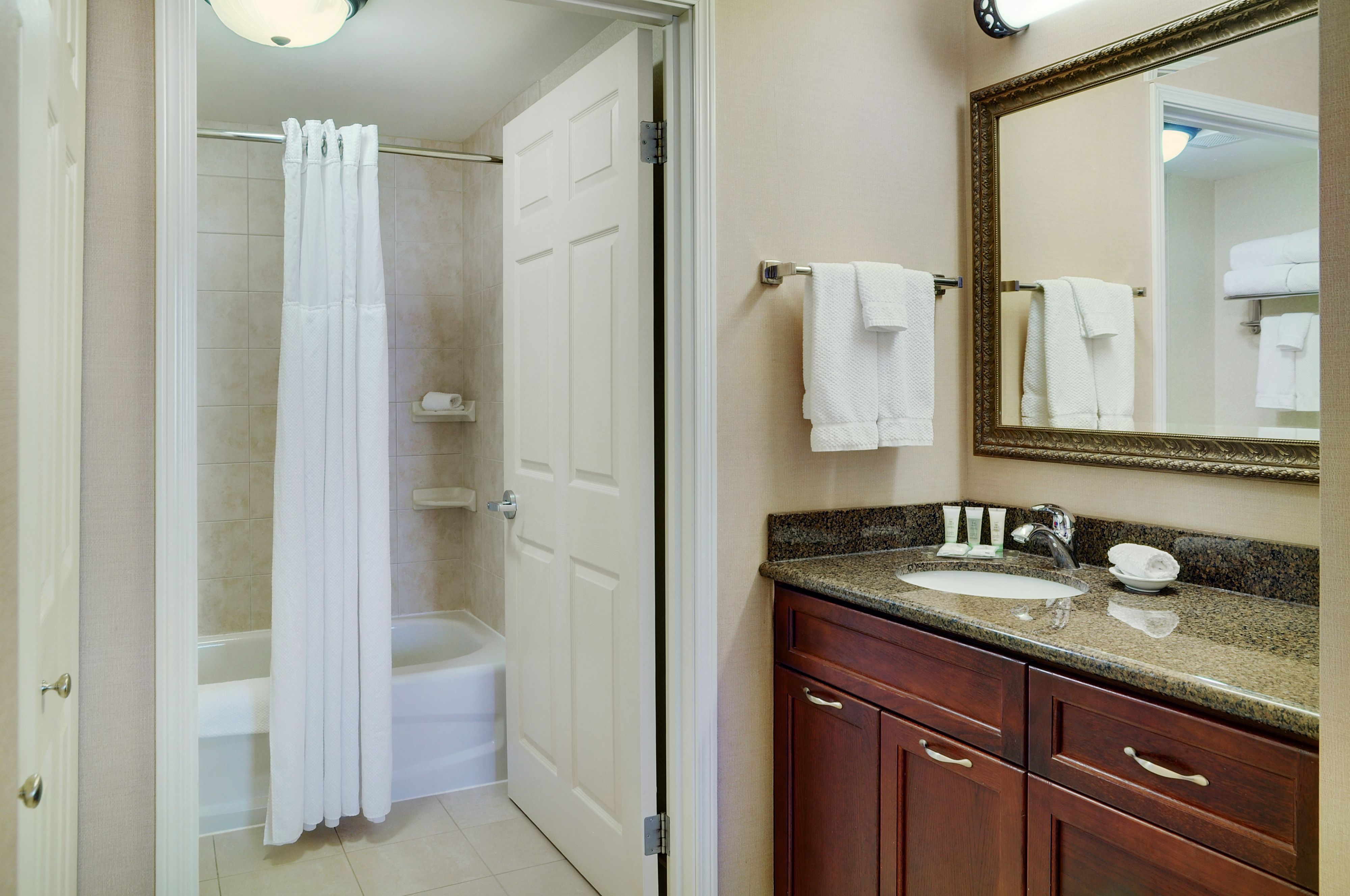 image Bathroom with contemporary fixtures and ample counter space.