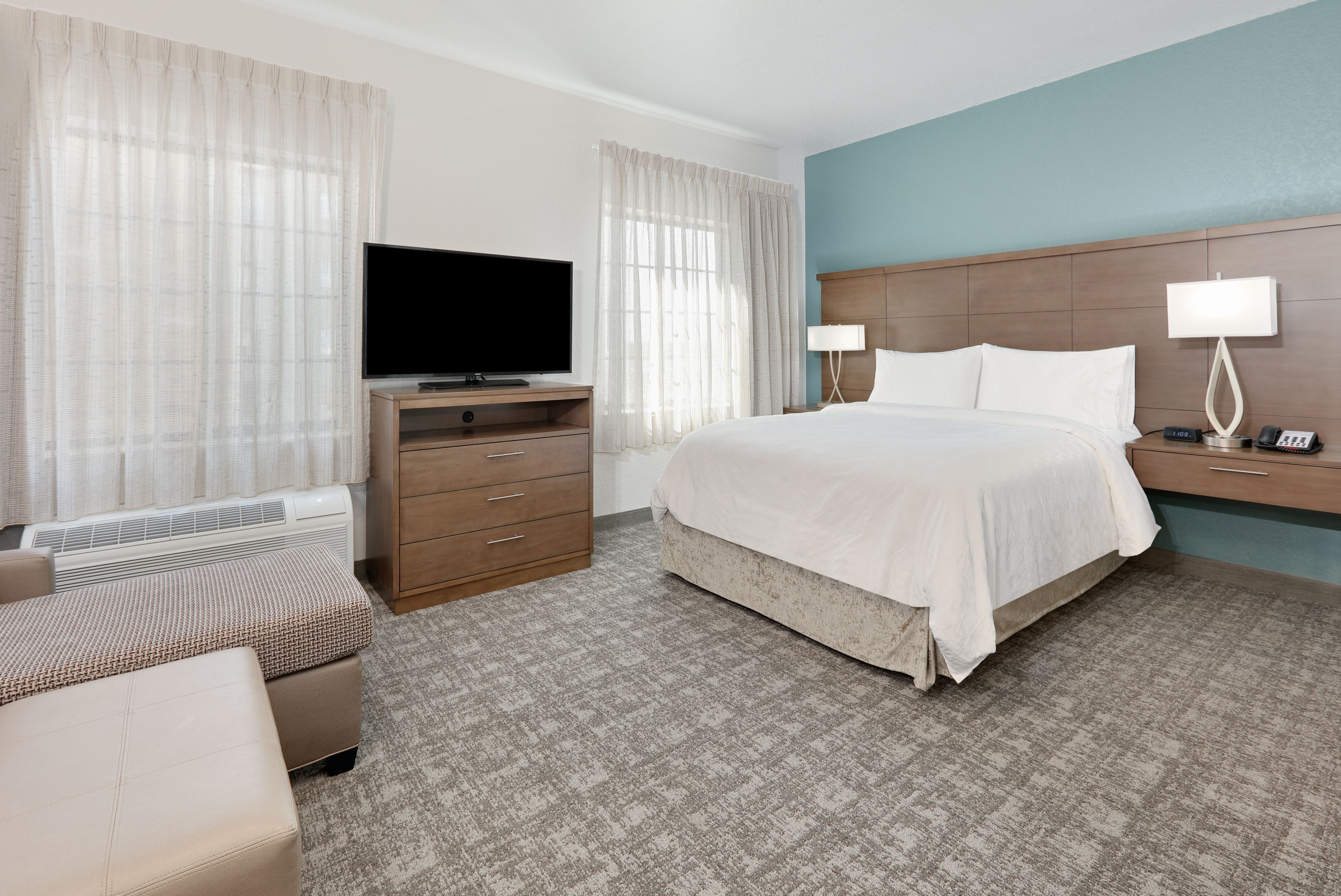 image Inviting sleeping area with ample natural light and contemporary furnishings.