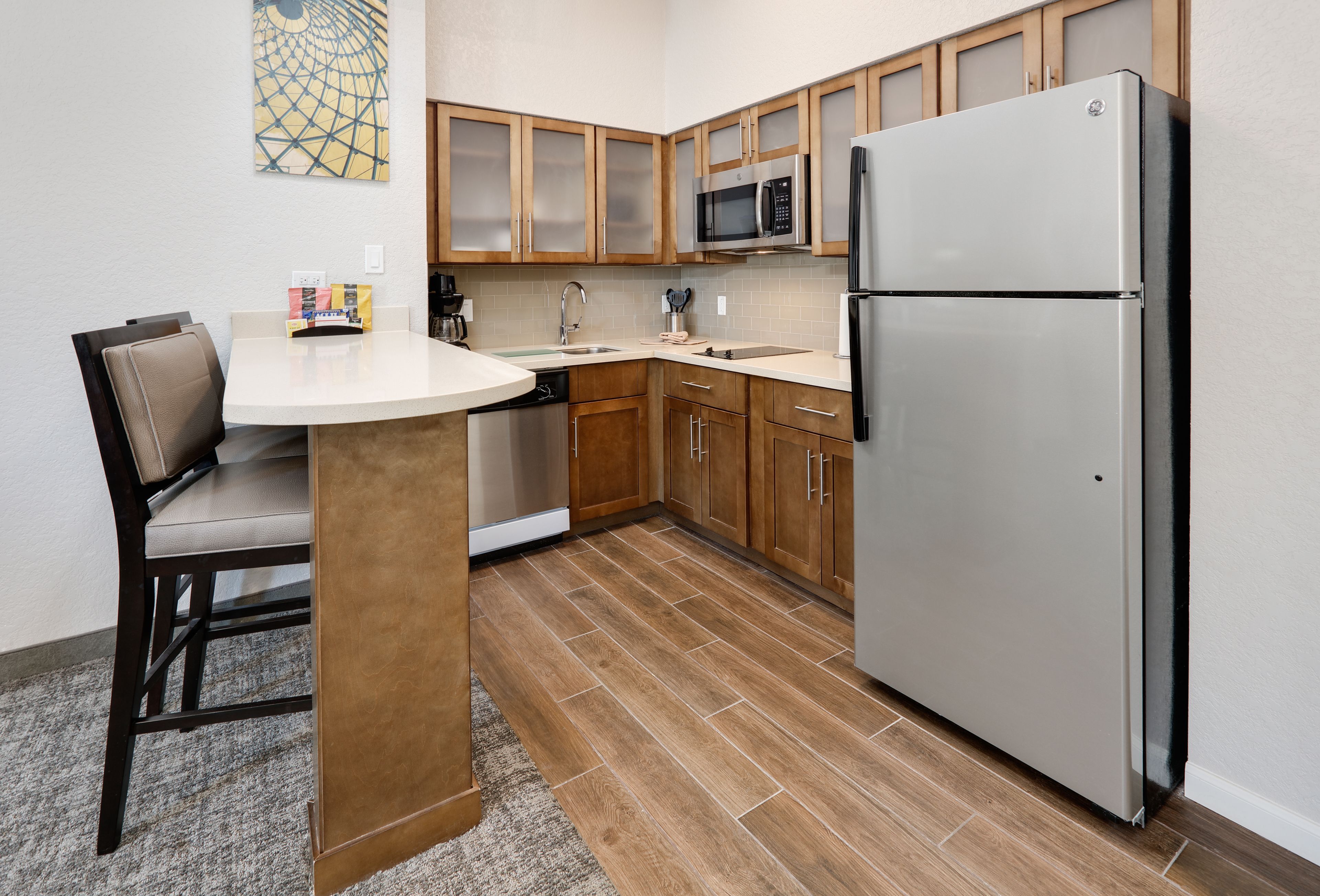 image Fully equipped kitchen with stainless steel appliances and bar seating.