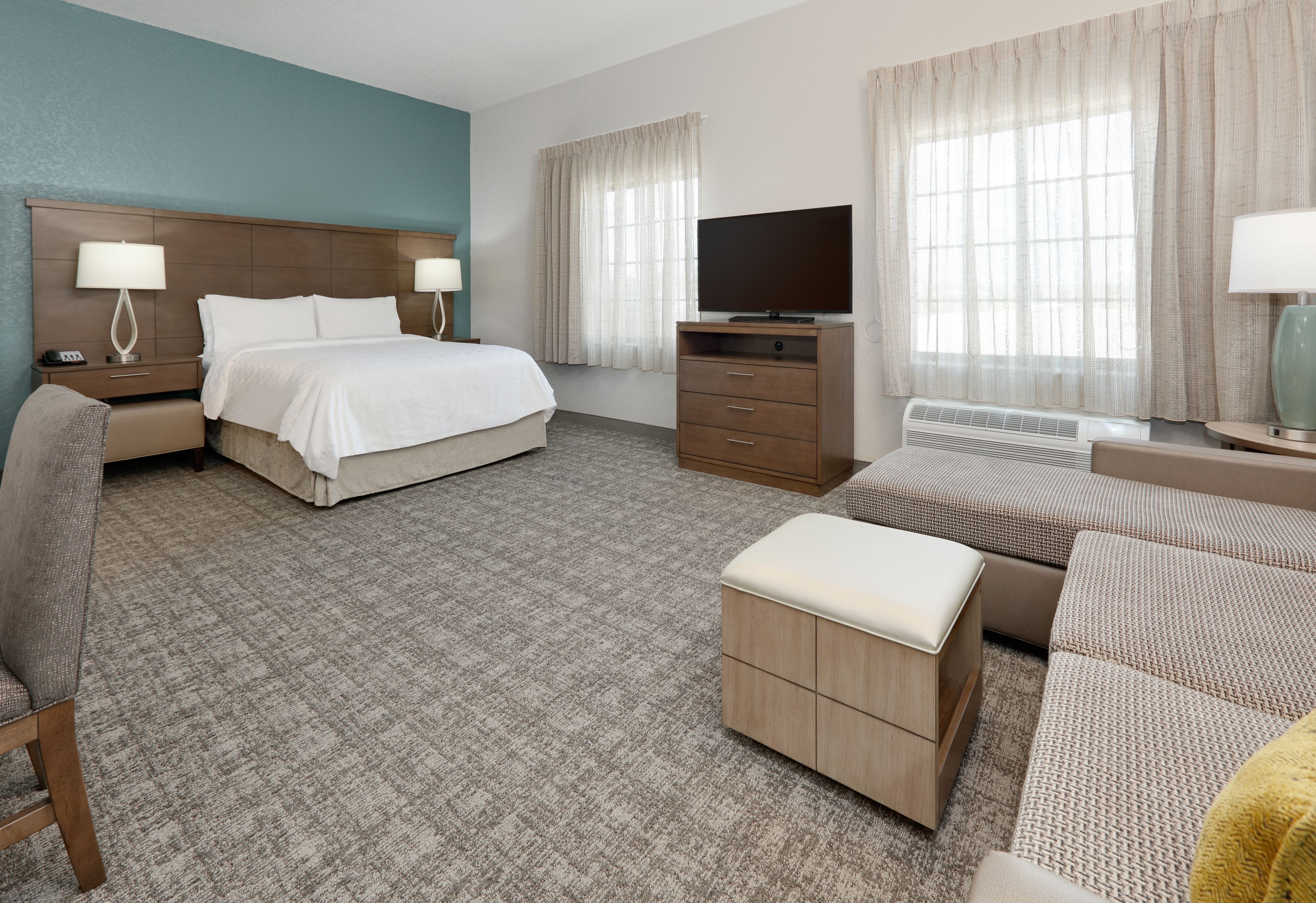 image Cozy queen studio suite with warm décor and natural light.