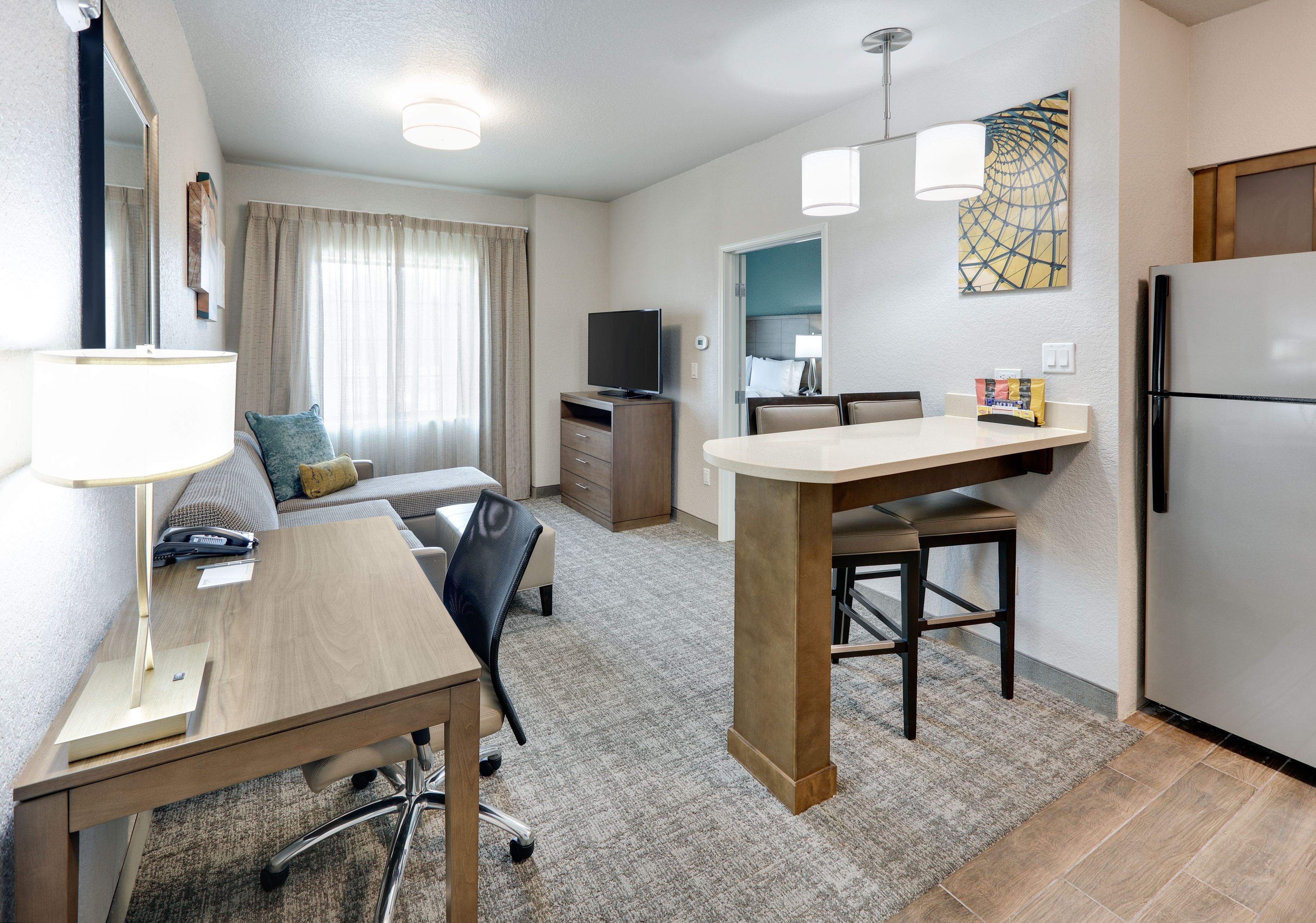 image Bright, inviting suite with separate living space and convenient amenities.