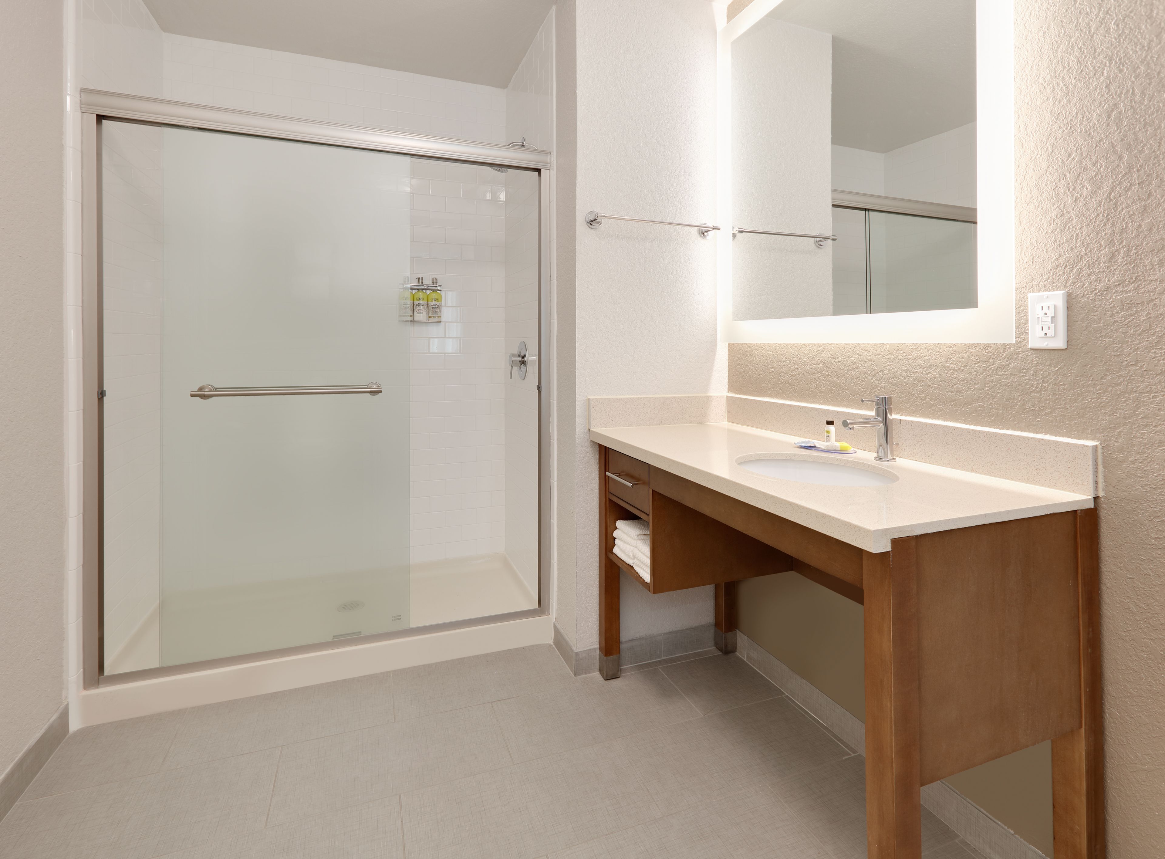 image Modern bathroom with walk-in shower and sleek vanity.