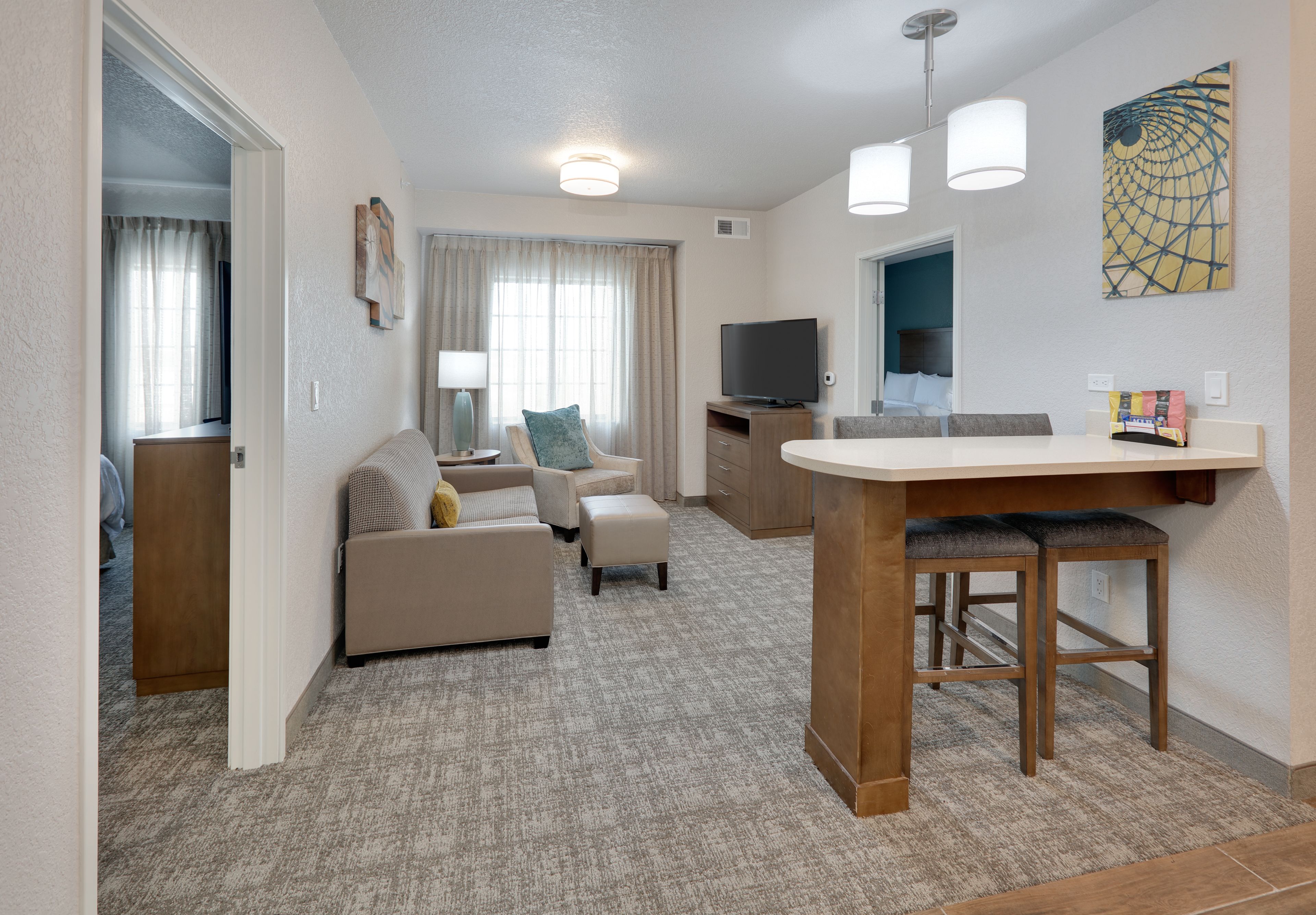 image Inviting living space with cozy sofa, TV, and dining area.