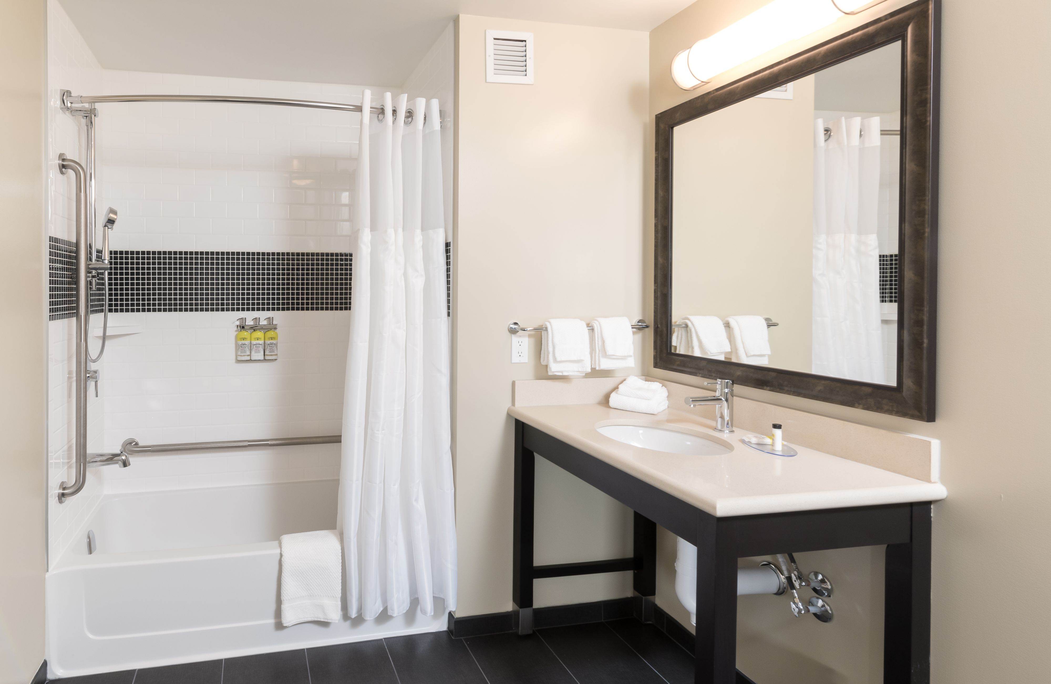 image Bathroom with shower and tub combination and contemporary finishes.
