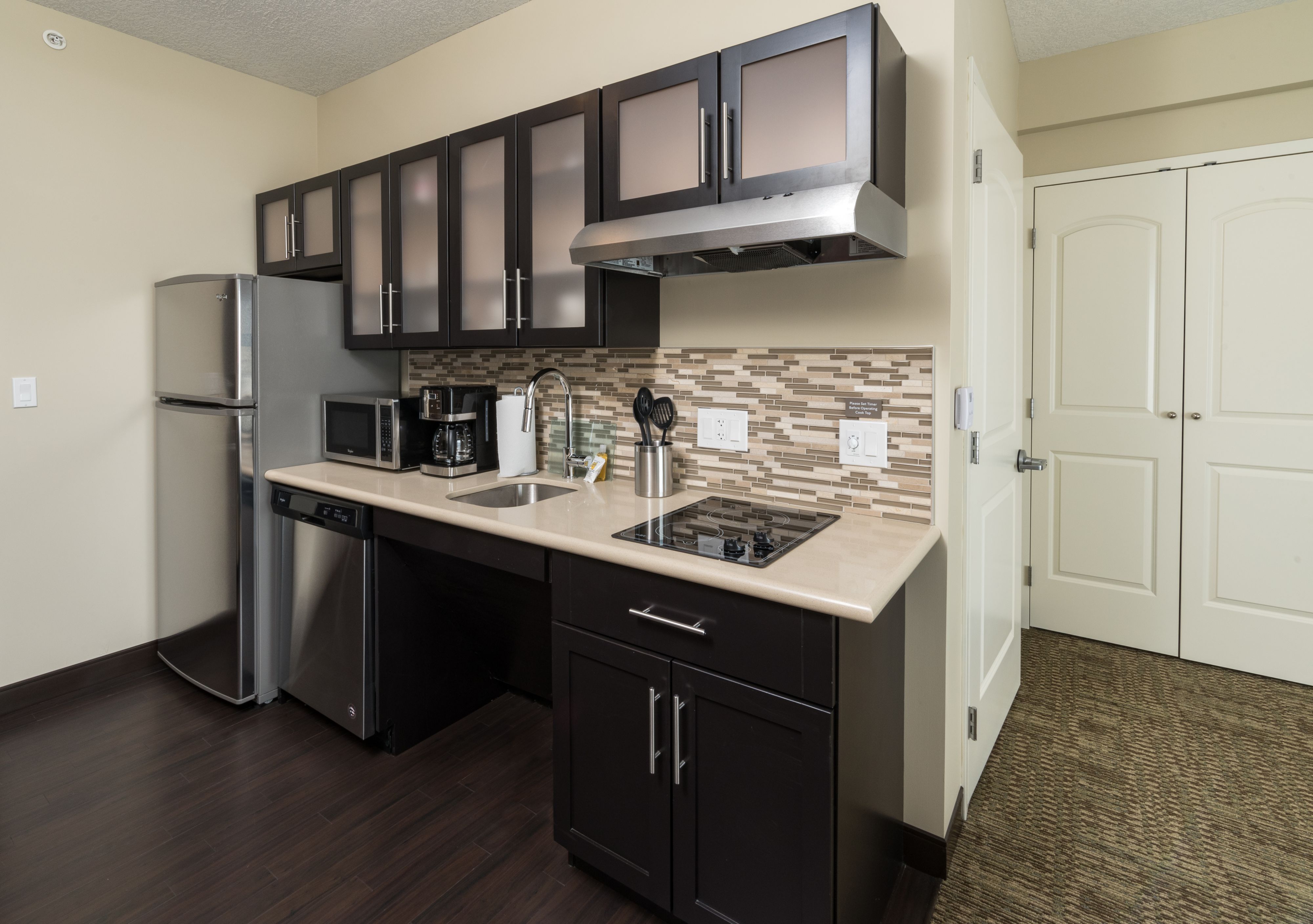 image Fully equipped kitchen with stainless steel appliances and stylish cabinetry.
