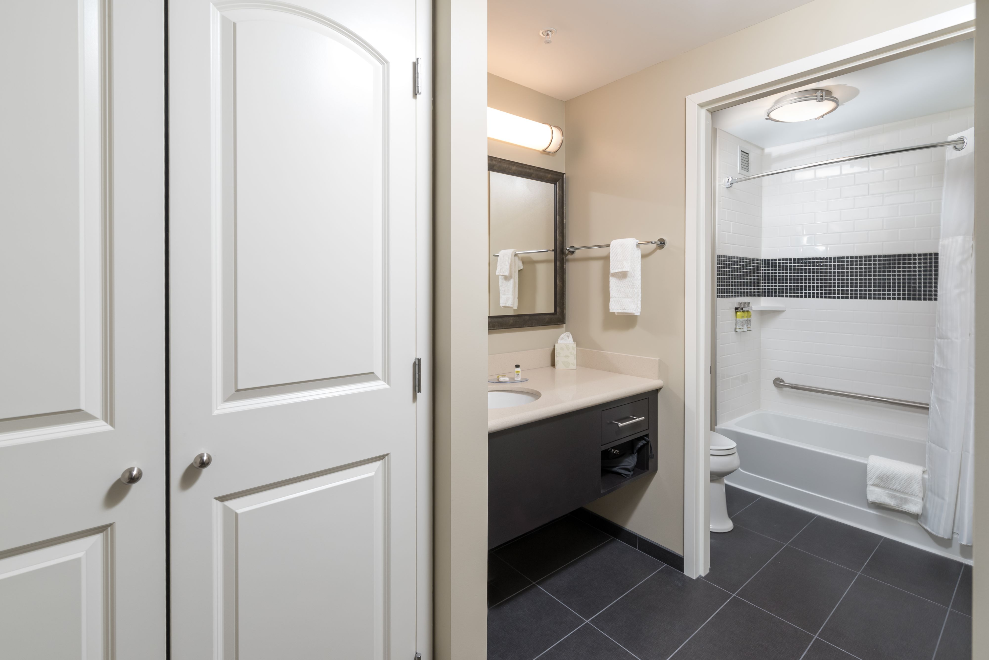 image Bathroom with large mirror and stylish modern fixtures.