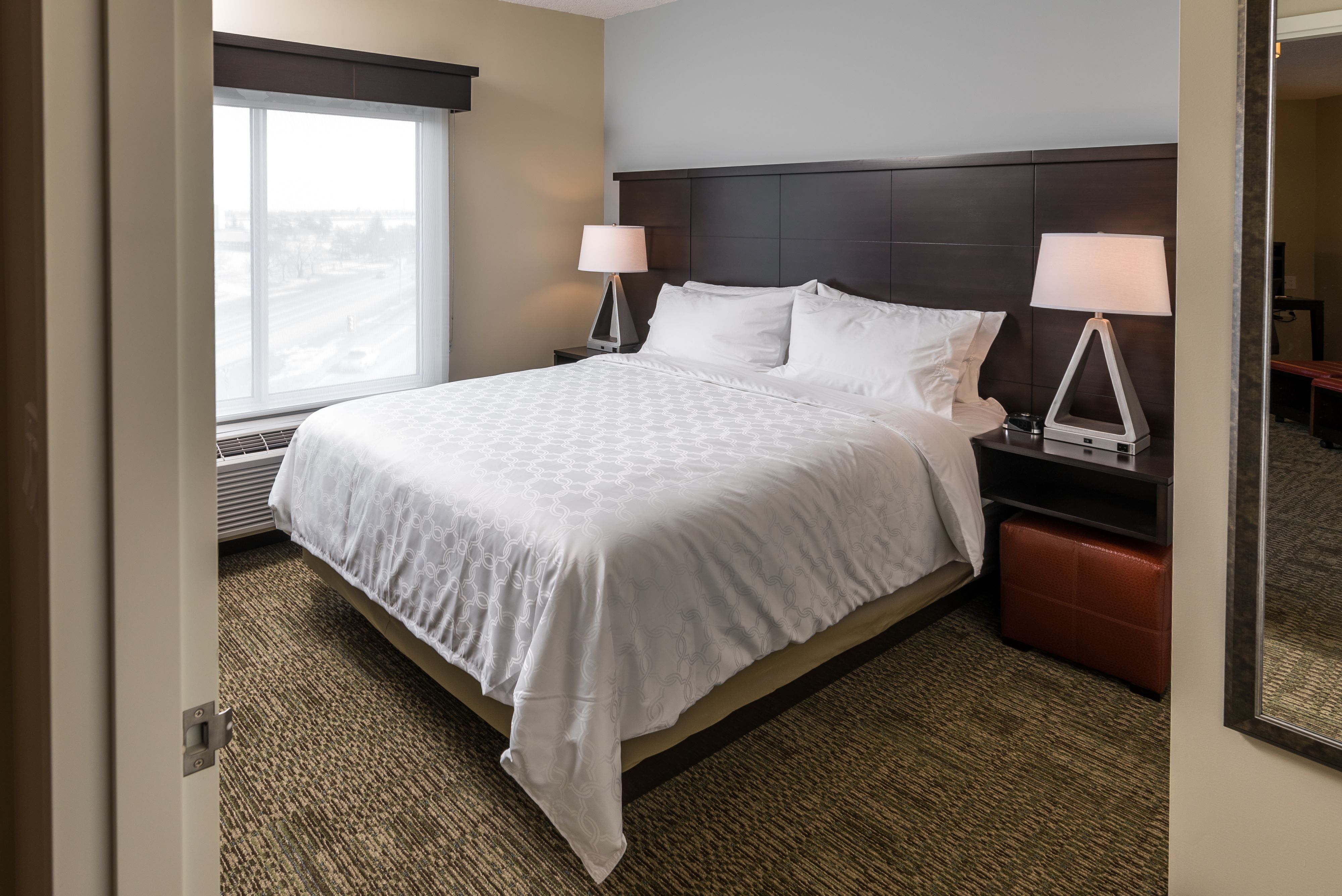 image Spacious bedroom with large bed and beautiful natural light.