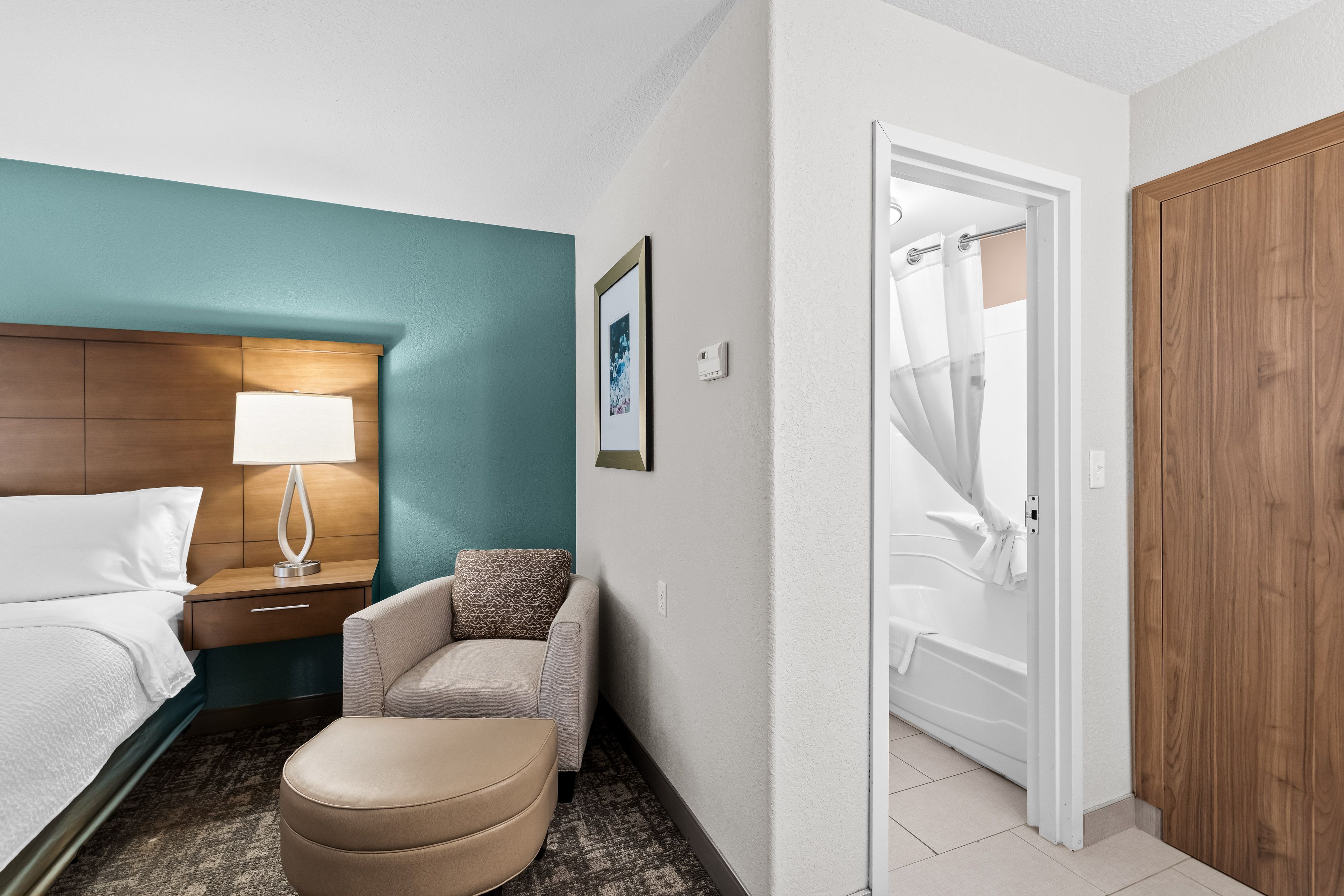image Comfortable sleeping area with cosy seating and a calming, well-appointed feel.