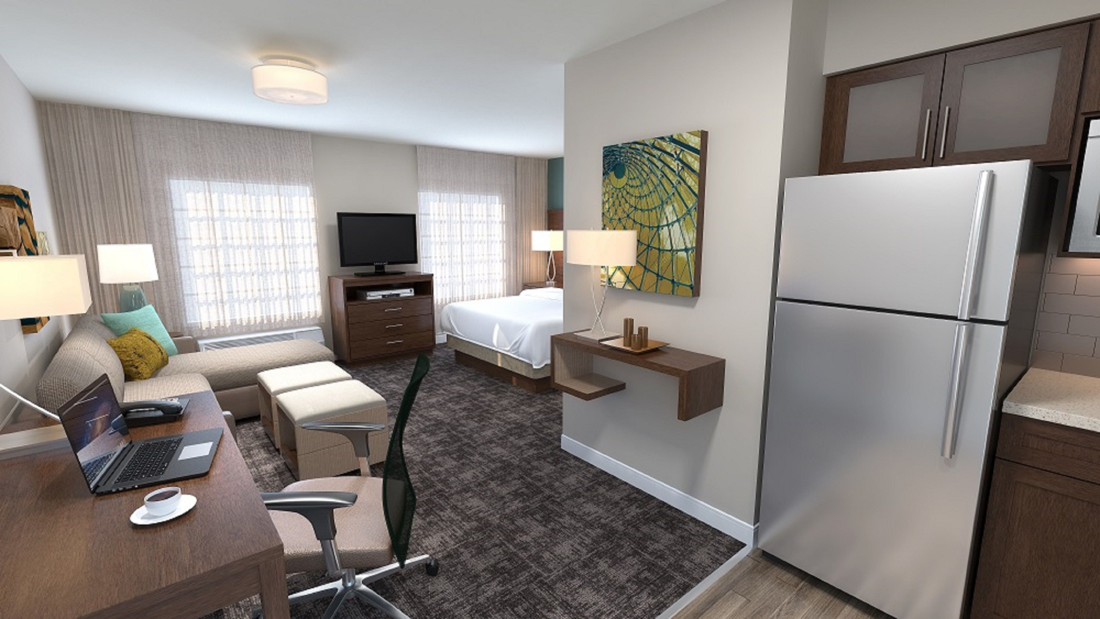 image Open-plan studio with living area and fully equipped kitchen.