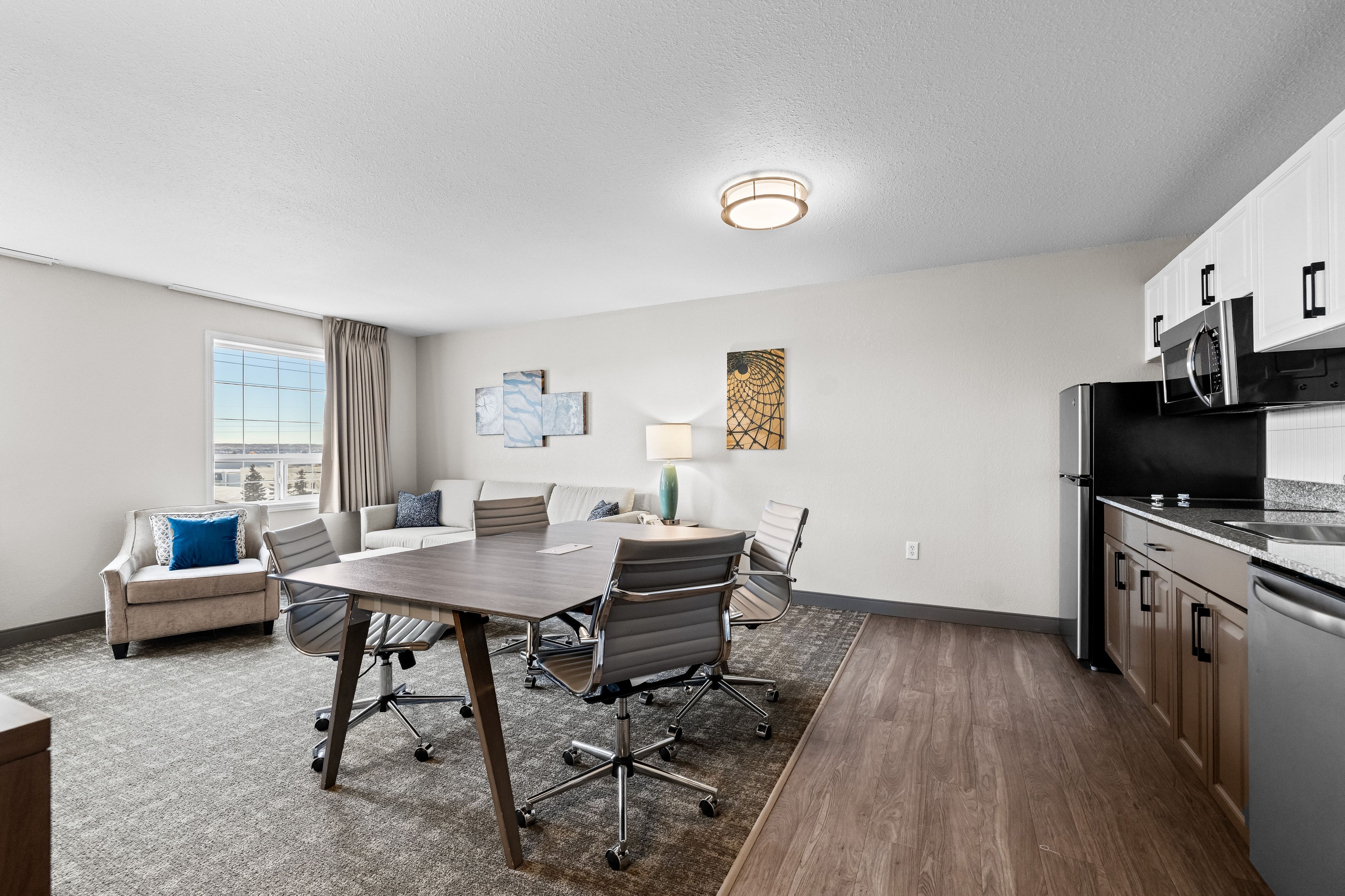 image Bright kitchen and dining area with modern appliances.
