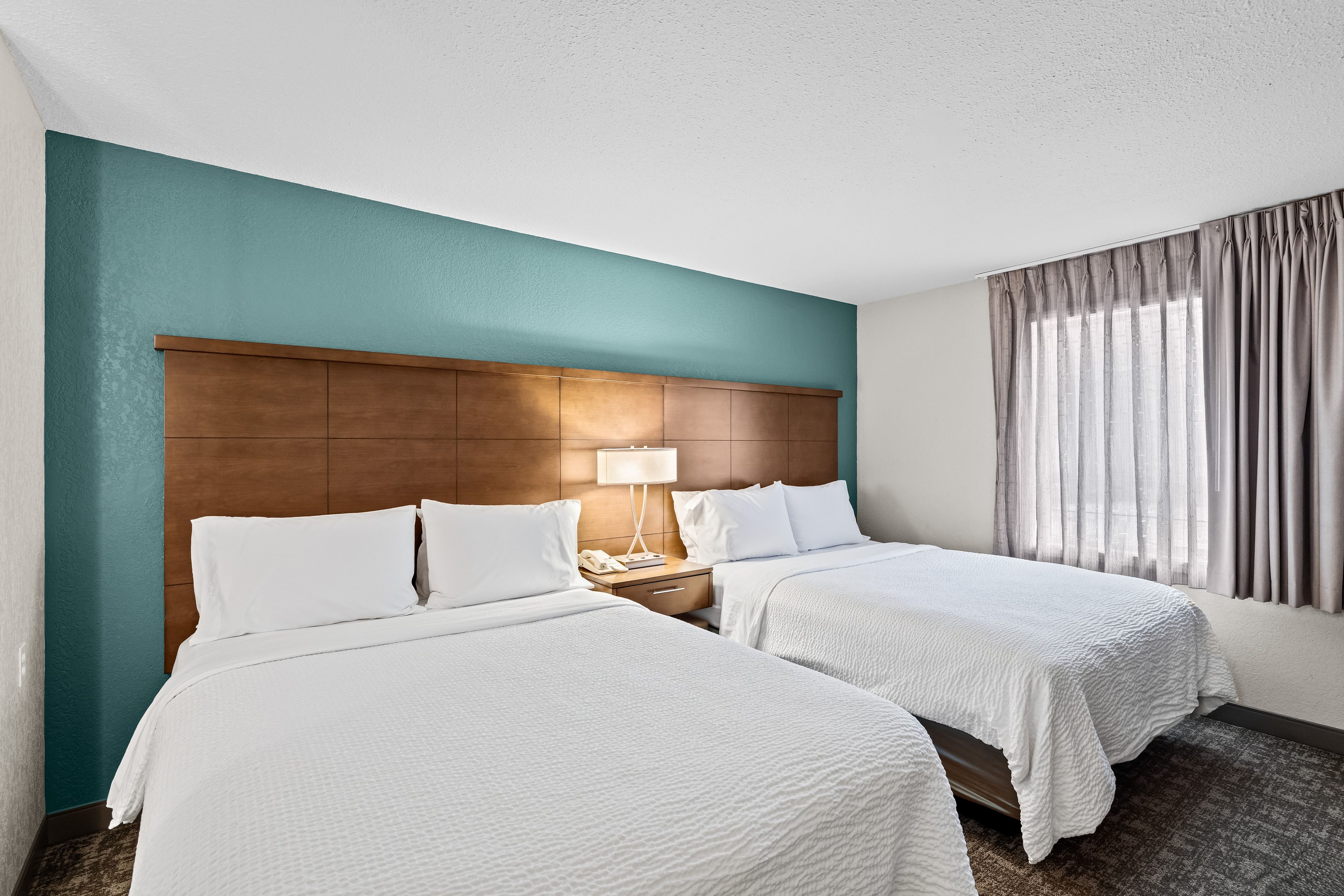 image Bedroom with two queen beds and natural light.