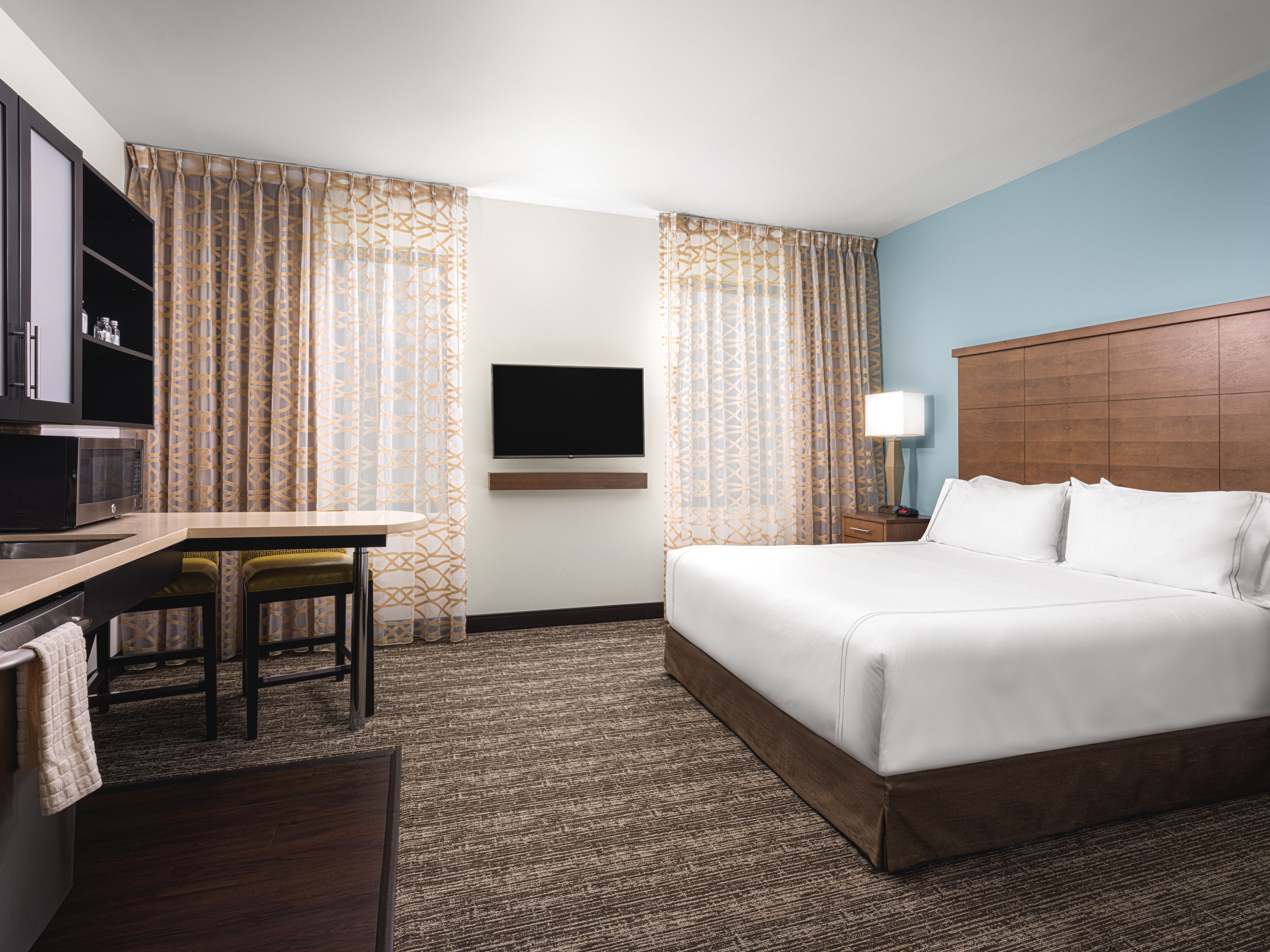 image Studio suite with king bed, kitchen, and TV.