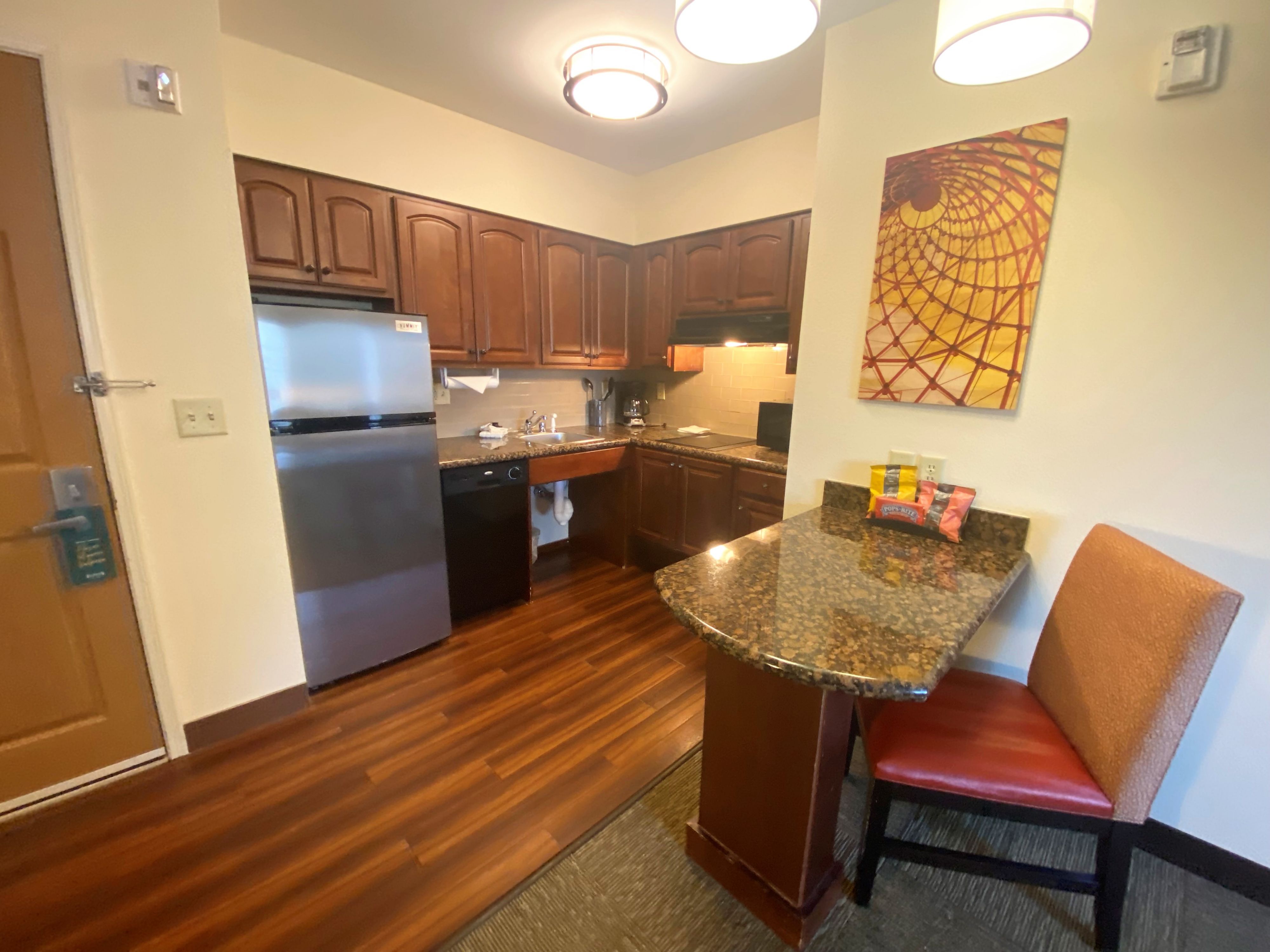 image Experience home cooking in this well-equipped kitchen featuring modern appliances and a warm atmosphere.
