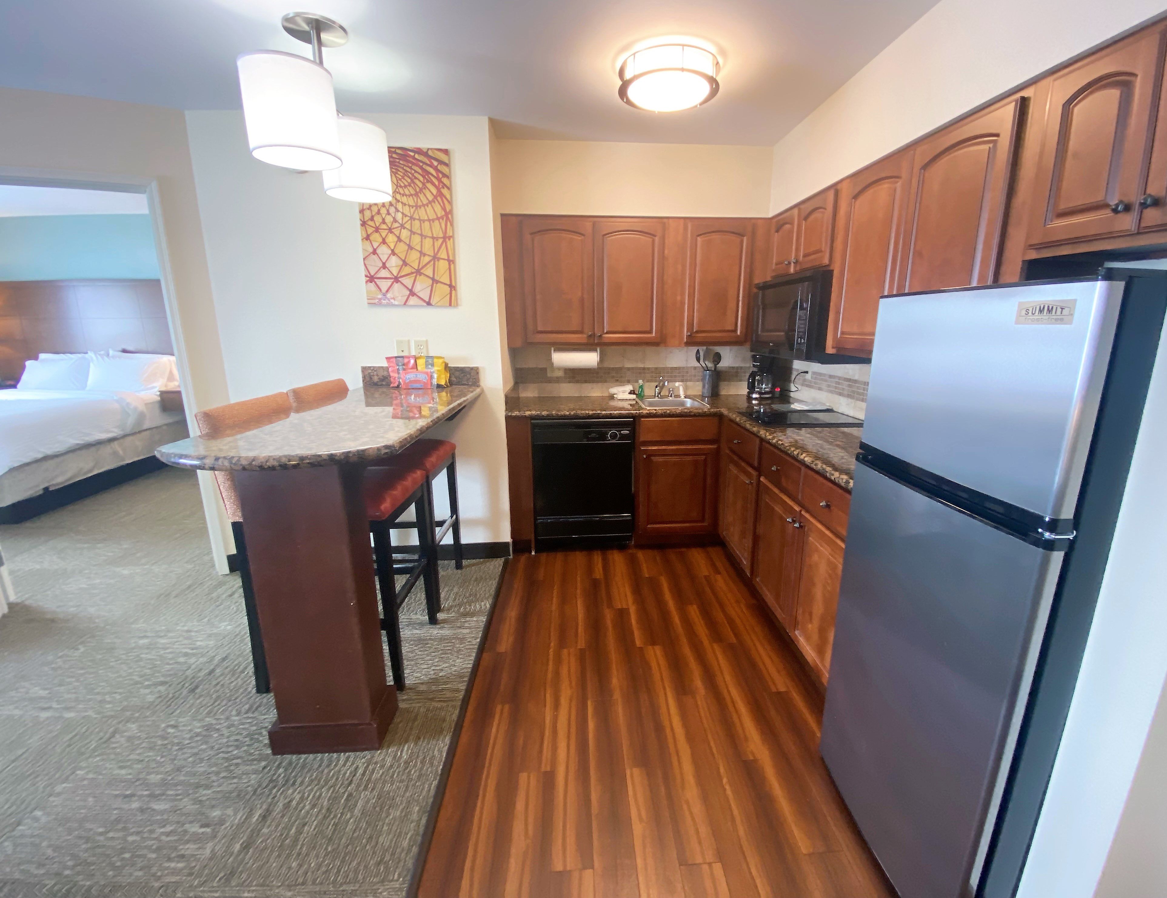image Cook up a storm in this stylish kitchen, equipped with modern appliances and a cozy breakfast bar.