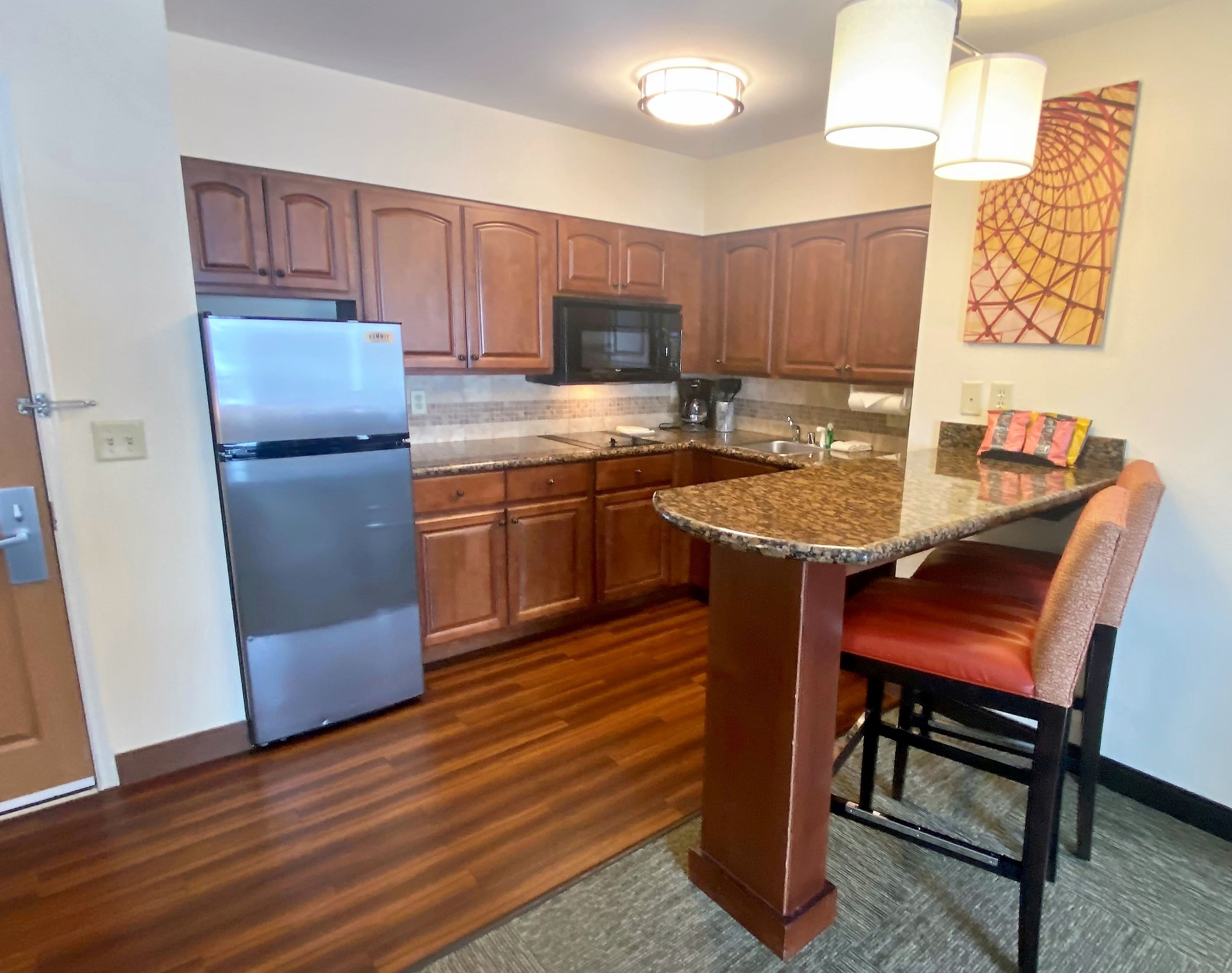 image Enjoy seamless meal prep with modern fixtures and a warm, inviting atmosphere in the kitchen.