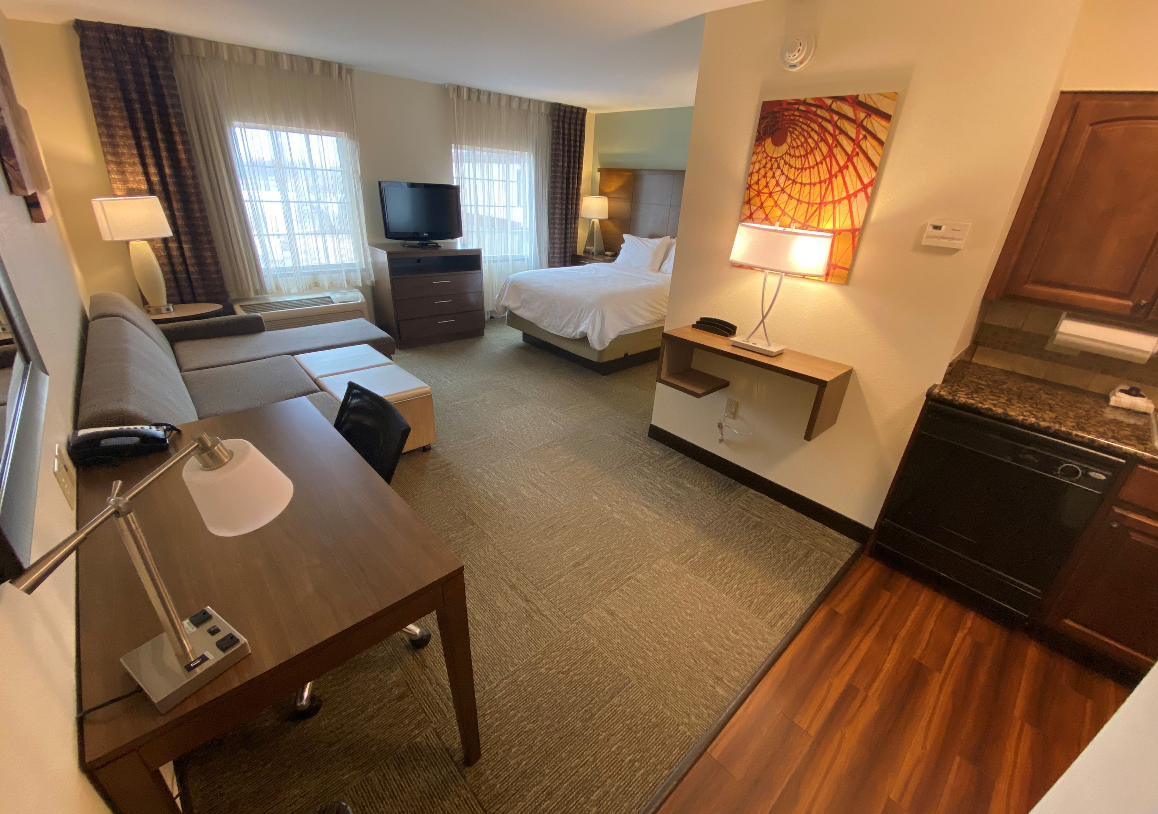 image Relax in this cozy studio, featuring a comfortable queen bed and inviting pull-out sofa.